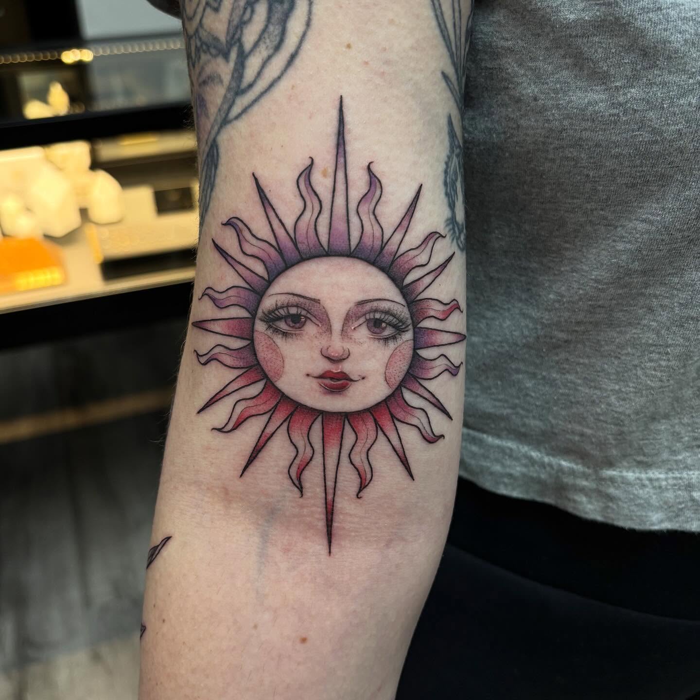 Sun face illustrative tattoo on the forearm by Hailey Nicole