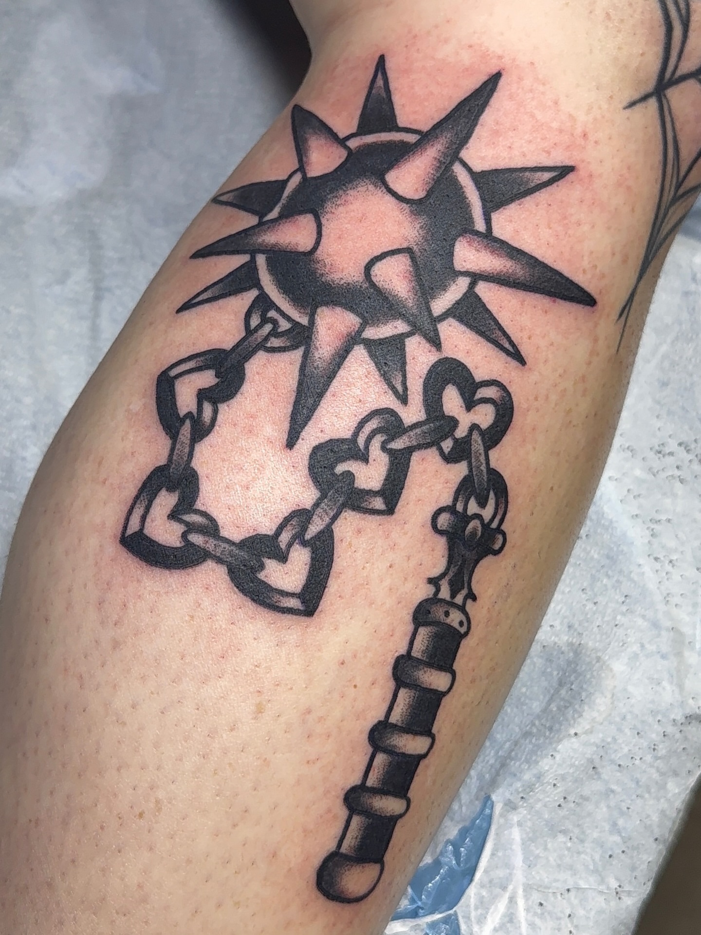 Chain and spiked ball black and grey tattoo on the forearm by VAY