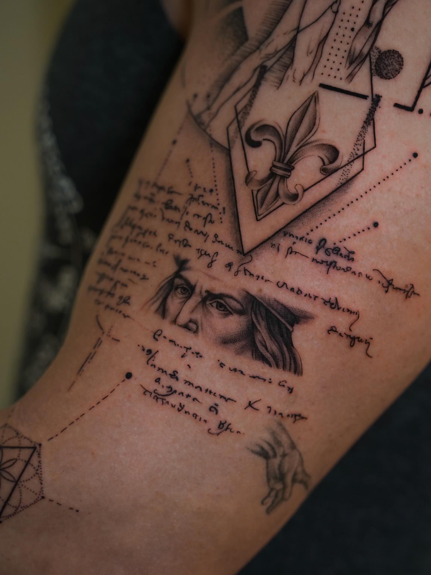 Portrait with fleur-de-lis realism tattoo on the forearm by Christian Guerrero