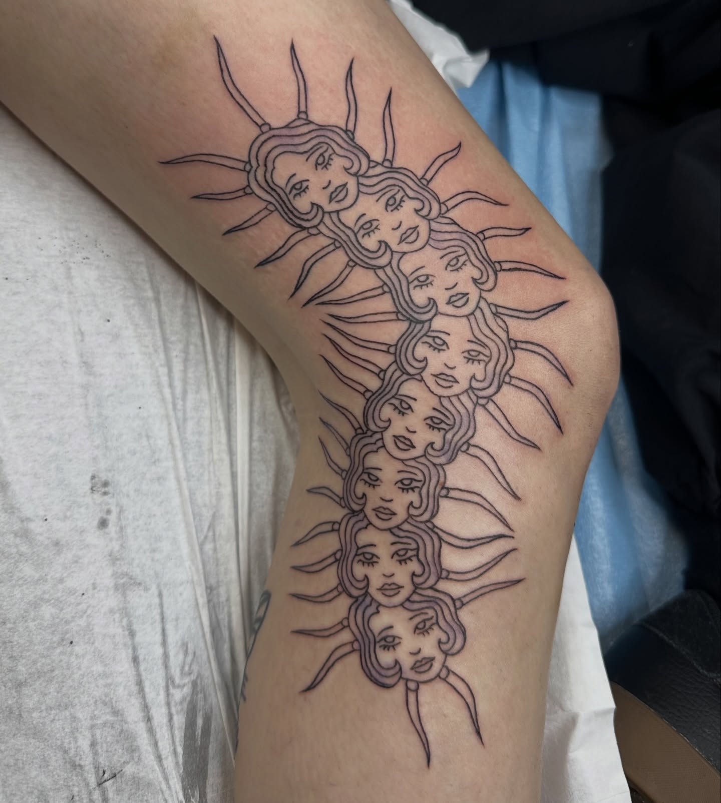 Stacked faces black and grey tattoo on the forearm by sechi