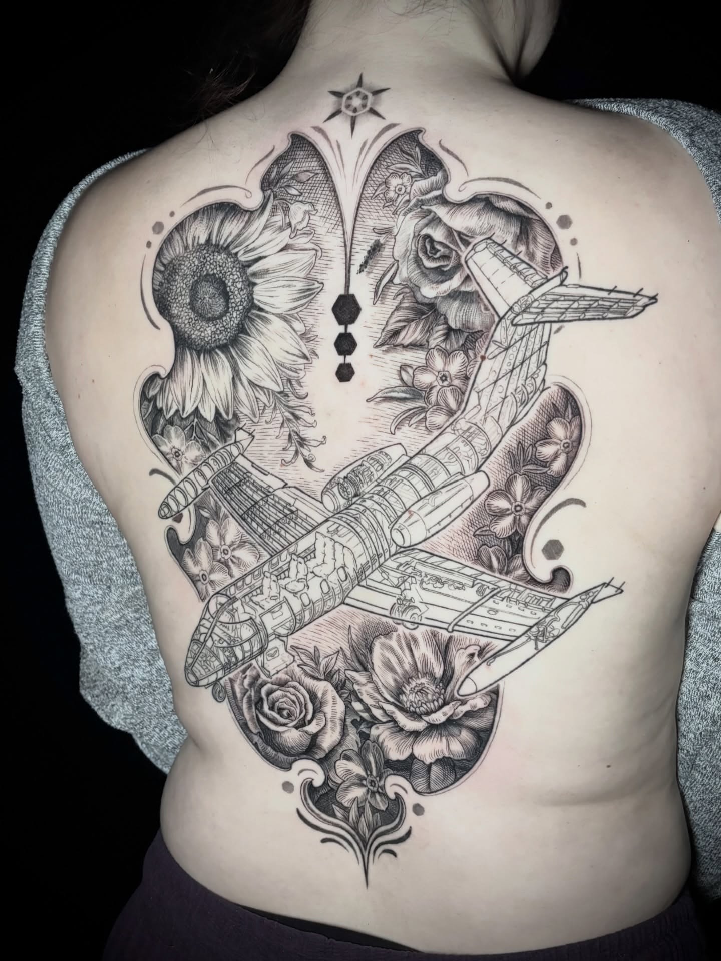 Airplane and sunflower dotwork tattoo on the back by Meg Mayhem ๐จ Sarenity Tattoo