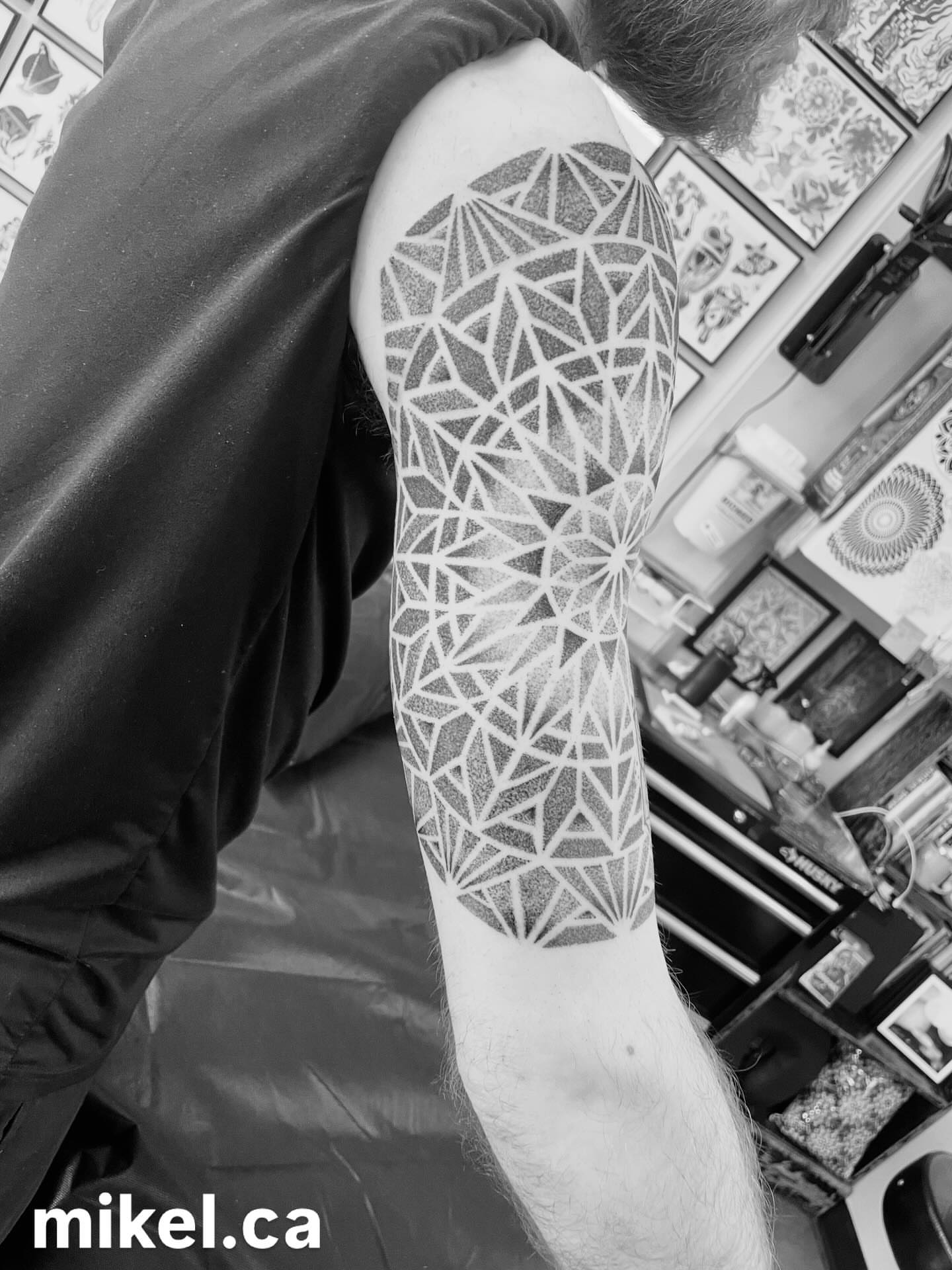Geometric pattern dotwork tattoo on the forearm by mikel_tattoosangha