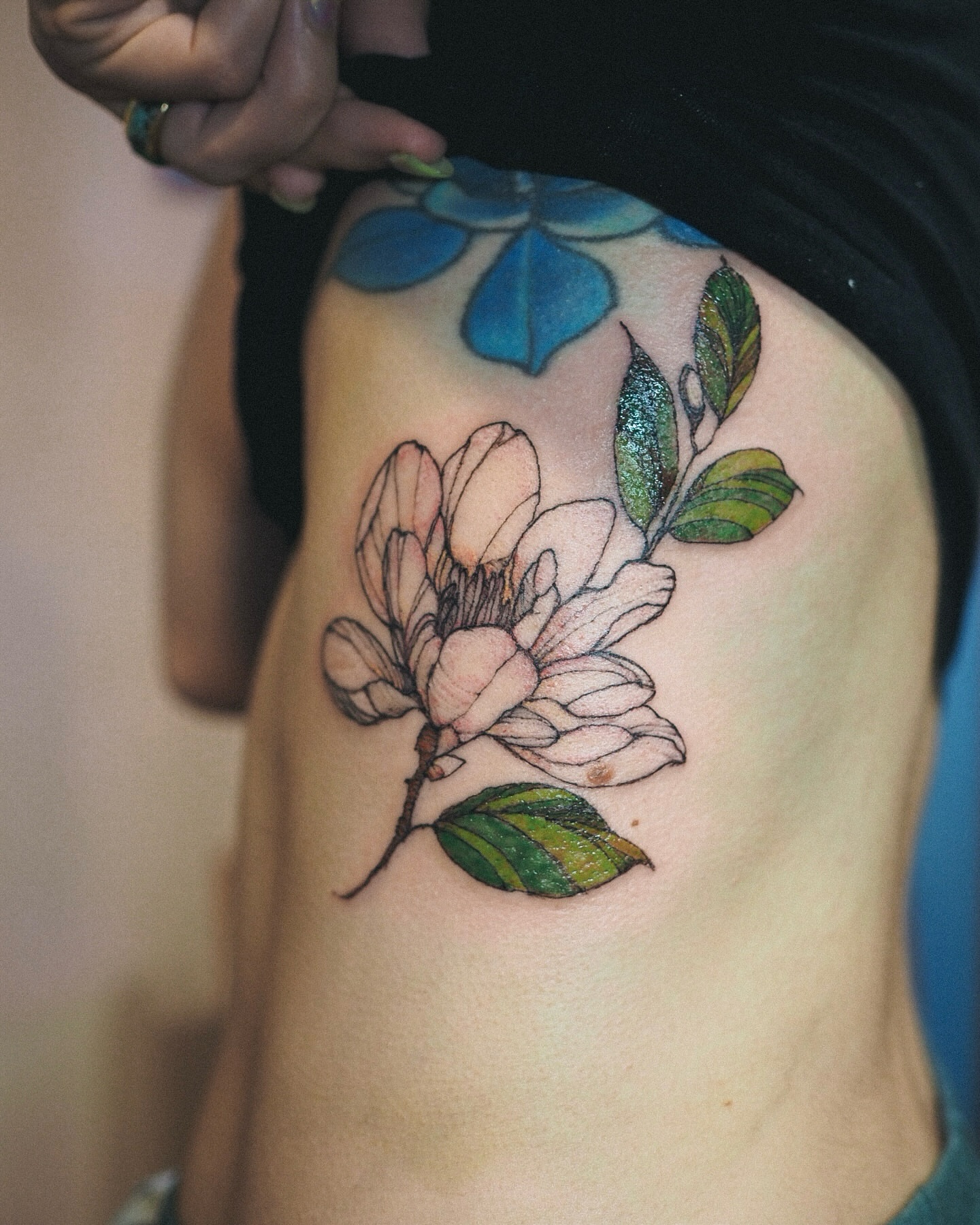 Magnolia flower realism tattoo on the thigh by Inks by Nastia