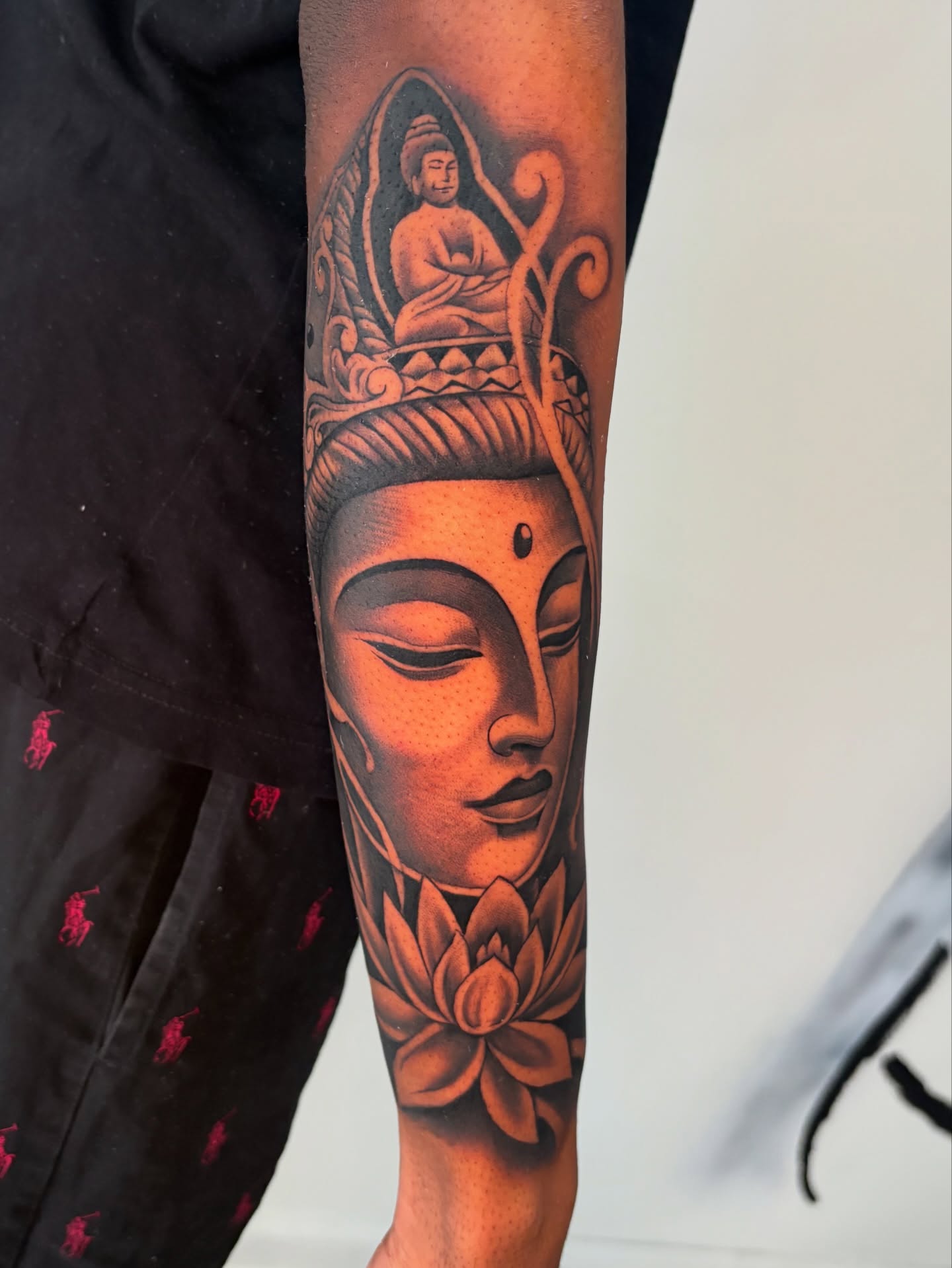 Buddha and lotus realism tattoo on the forearm by Osiel Rodriguez
