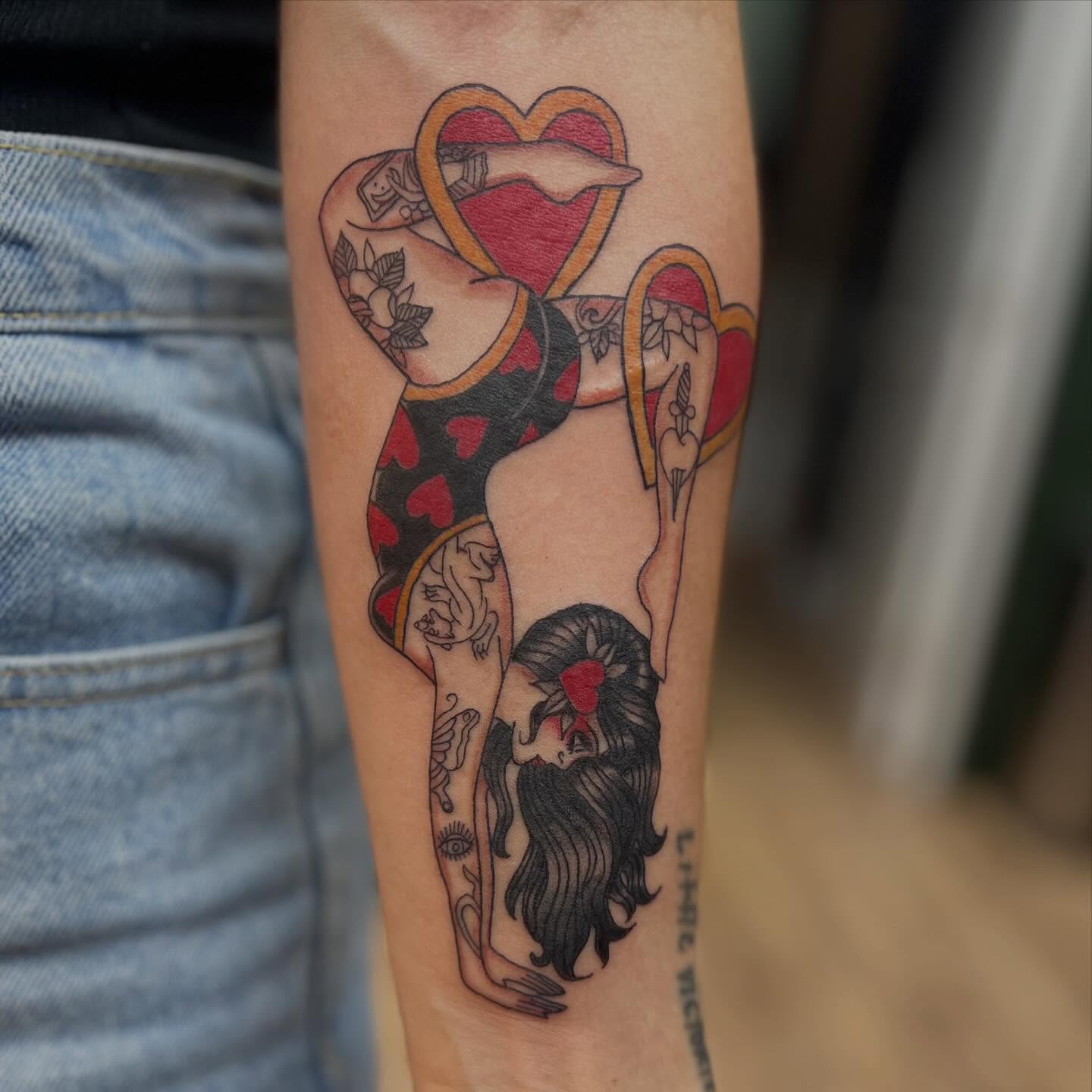 Woman with heart American traditional tattoo on the forearm by Victorian Coleman