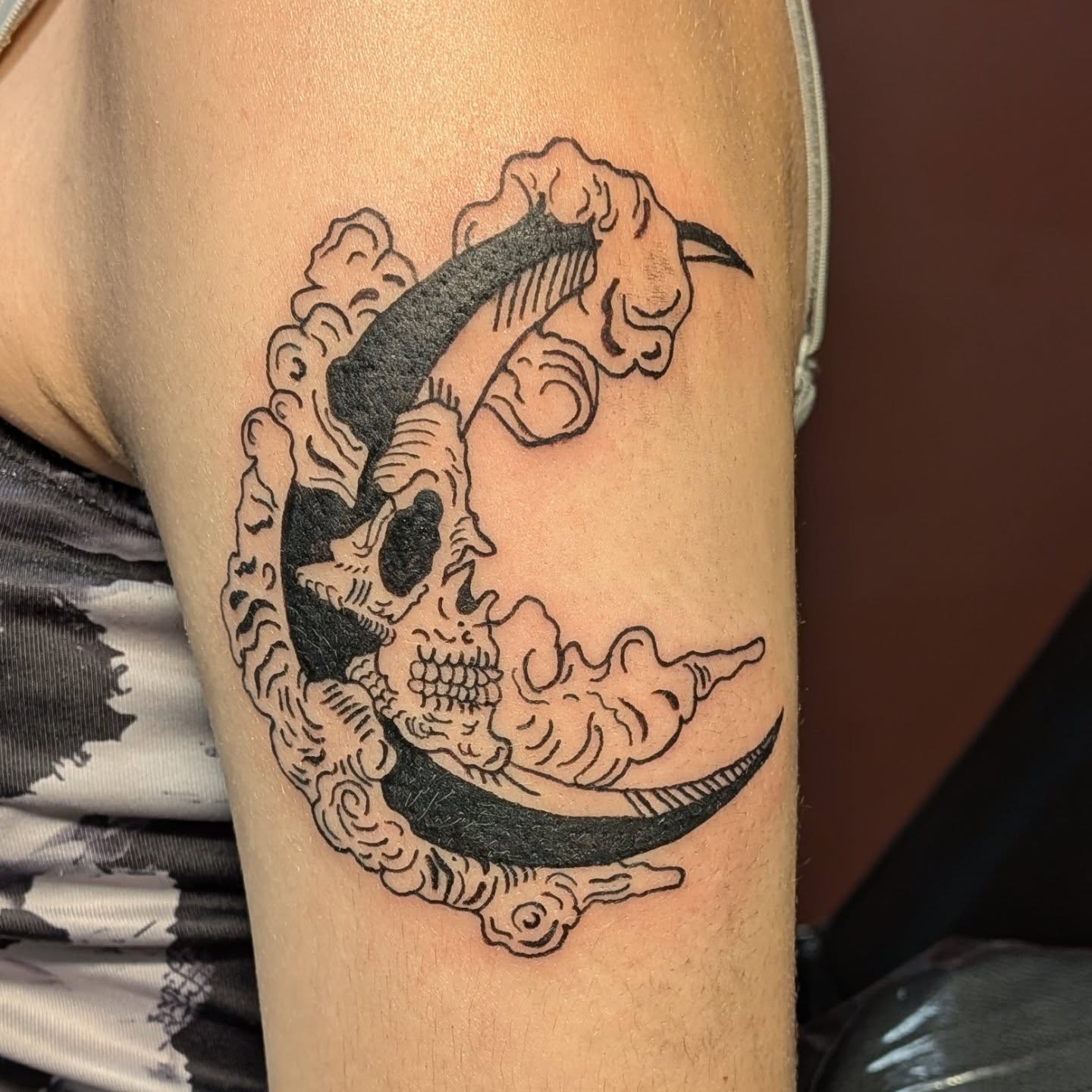 Skull and crescent moon American traditional tattoo on the forearm by Kam