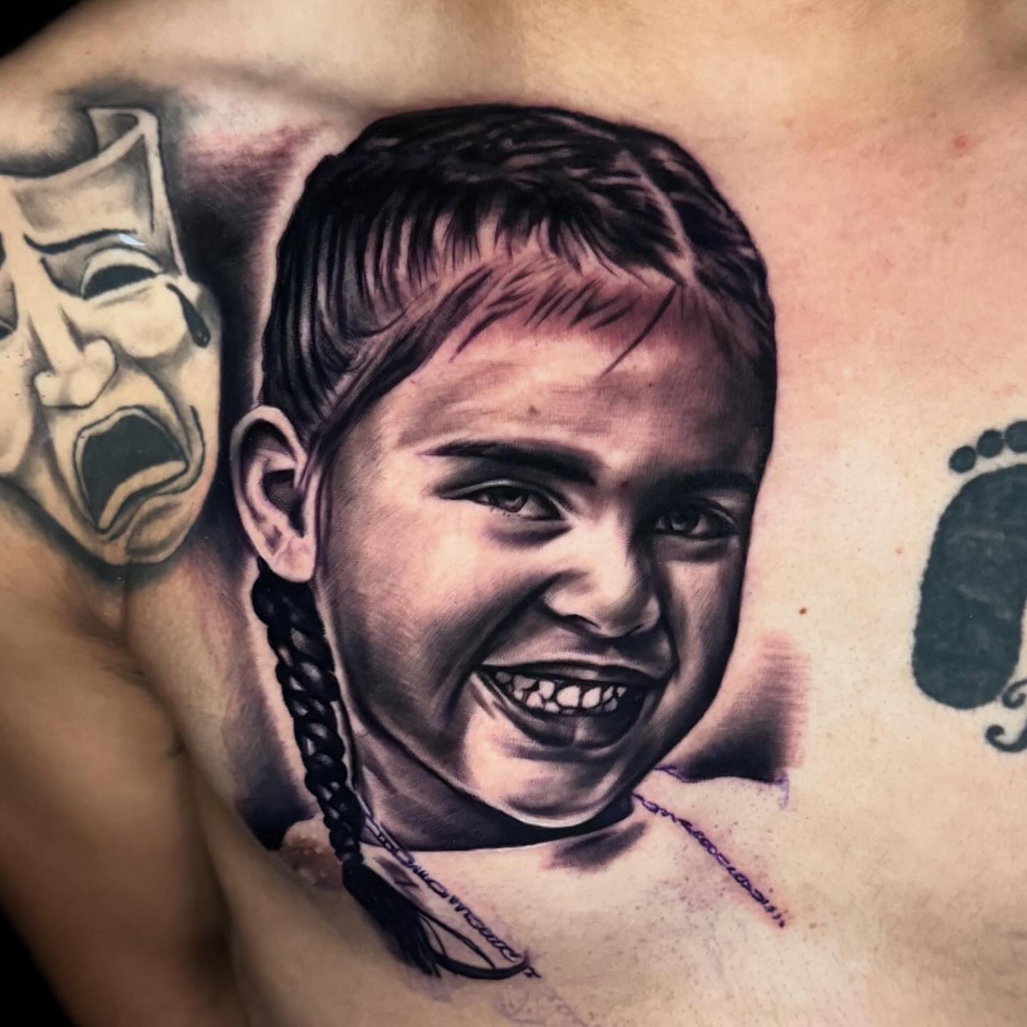 Child's face realism tattoo on the chest by Drink Ink Tattoos™ 👽