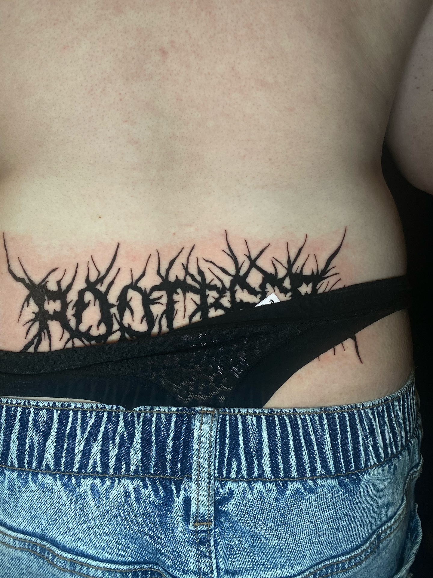 Rooted black and grey tattoo on the torso by Cherry Jane 🍒