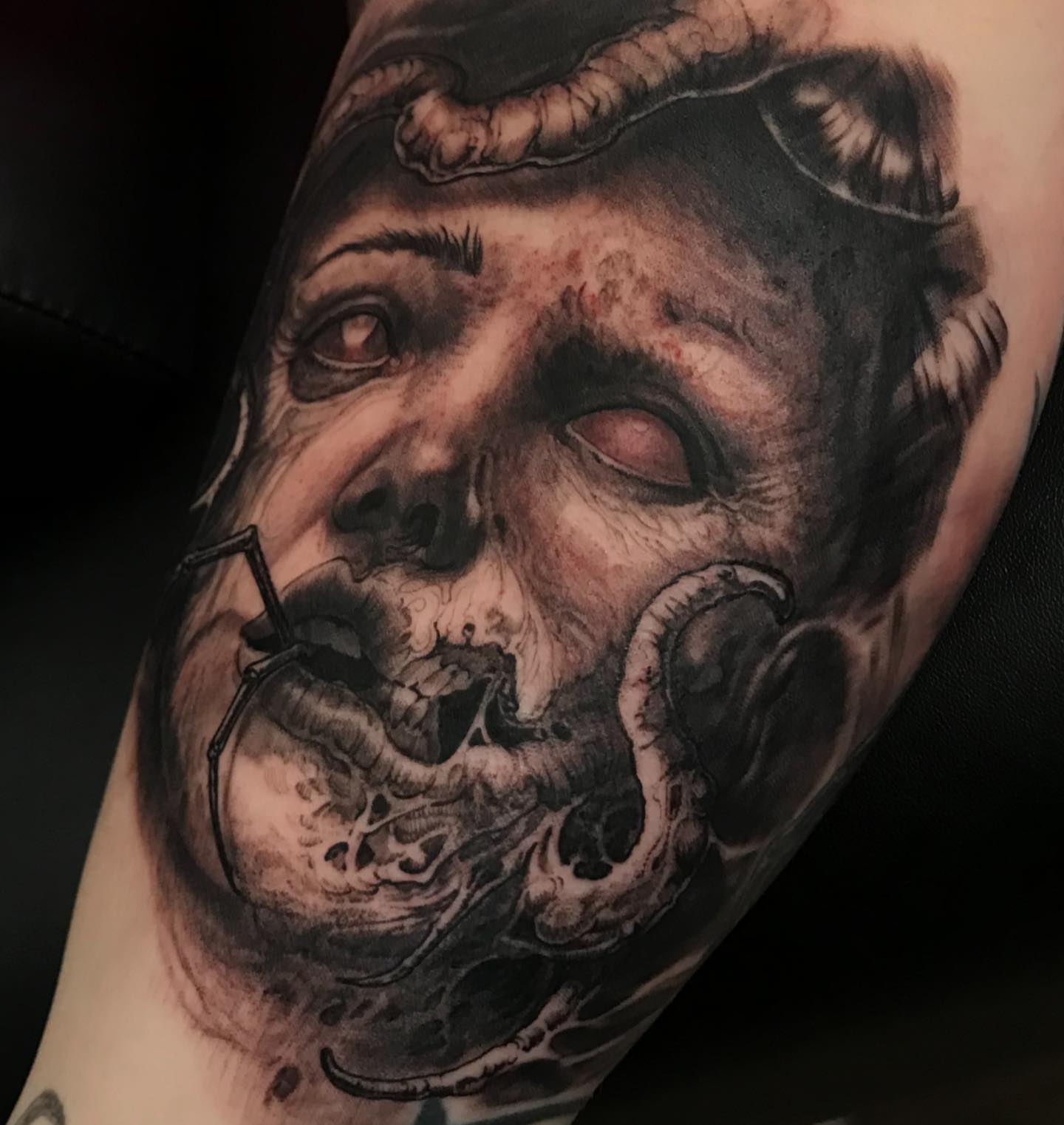 Zombie head dark realism tattoo on the forearm by Rick Rayne