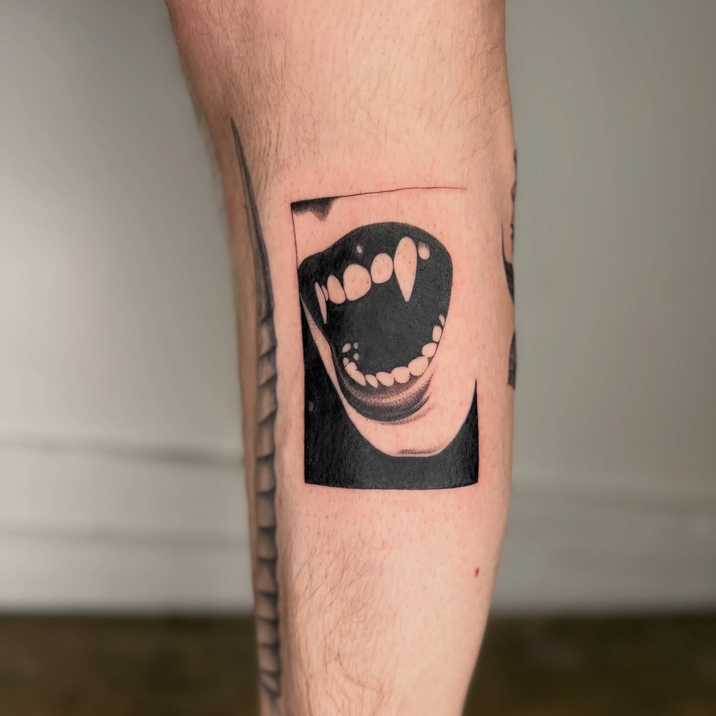 Smiling mouth black and grey tattoo on the forearm by Rose