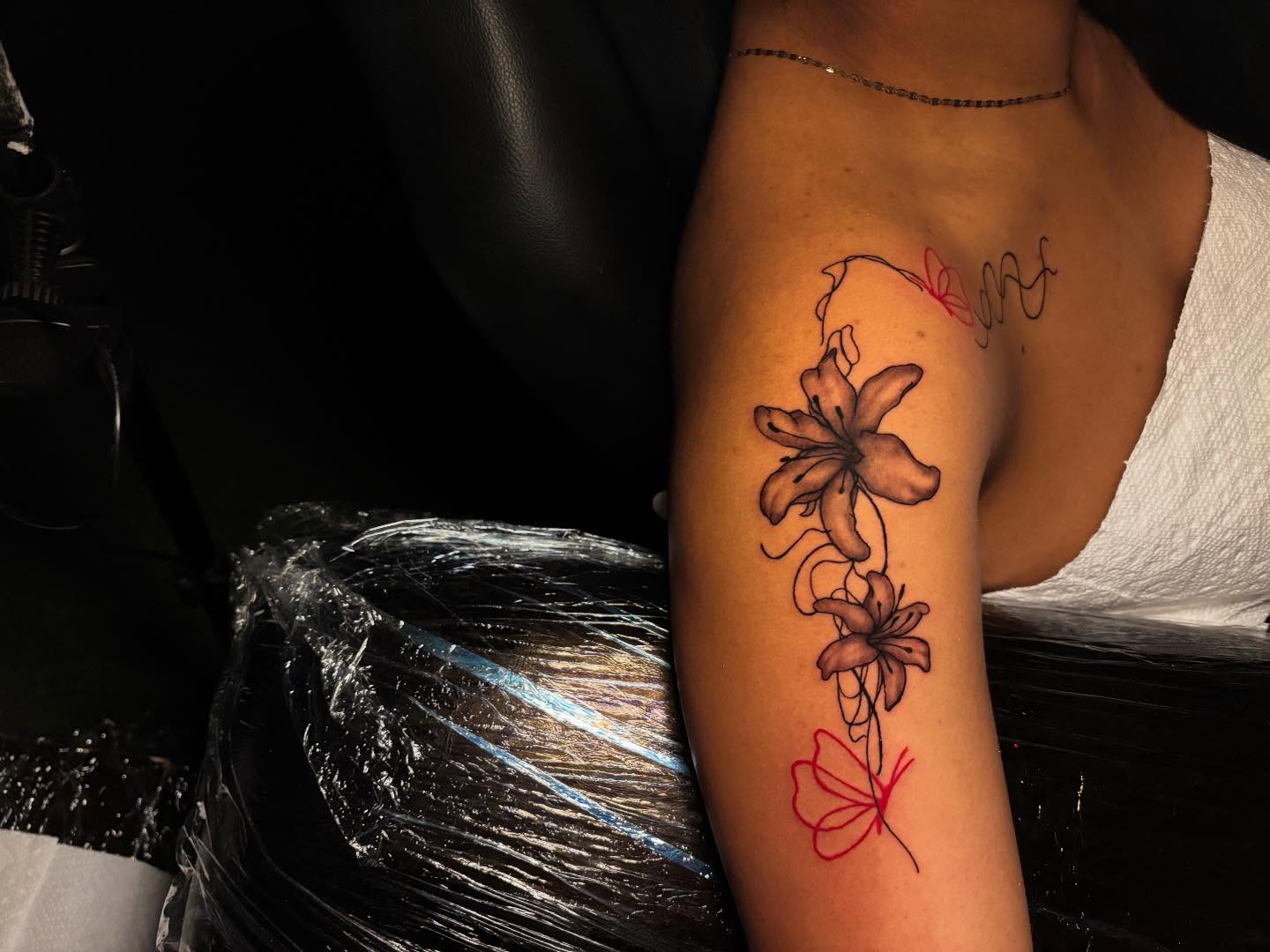 Lily flowers black and grey tattoo on the forearm by Inkys Tatts