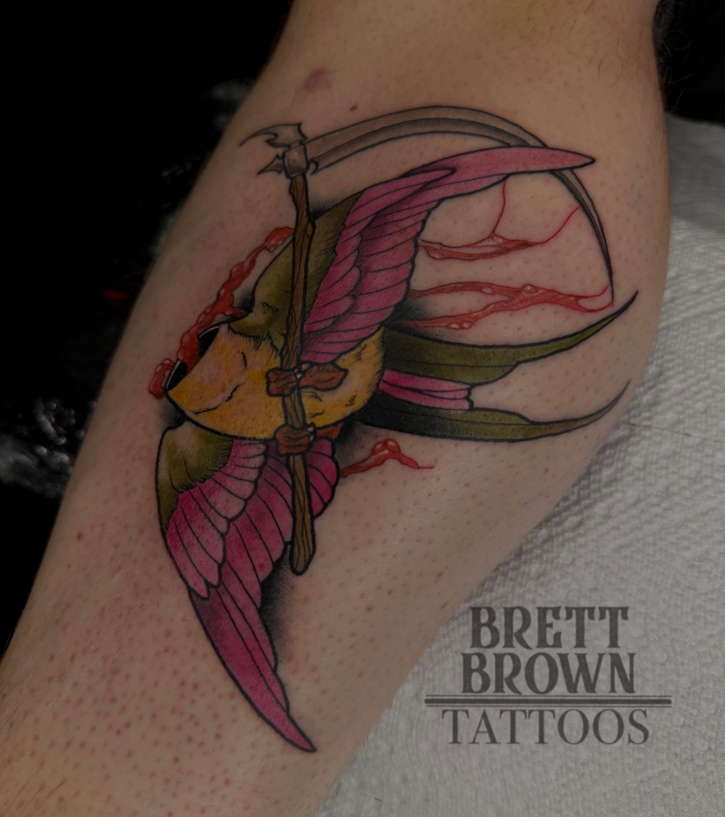 Winged creature with scythe new school tattoo on the forearm by Brett Brown