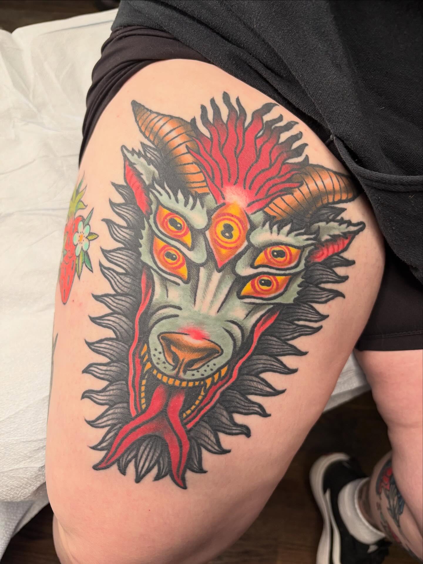 Goat head American traditional tattoo on the thigh by Sydney Pflaumer