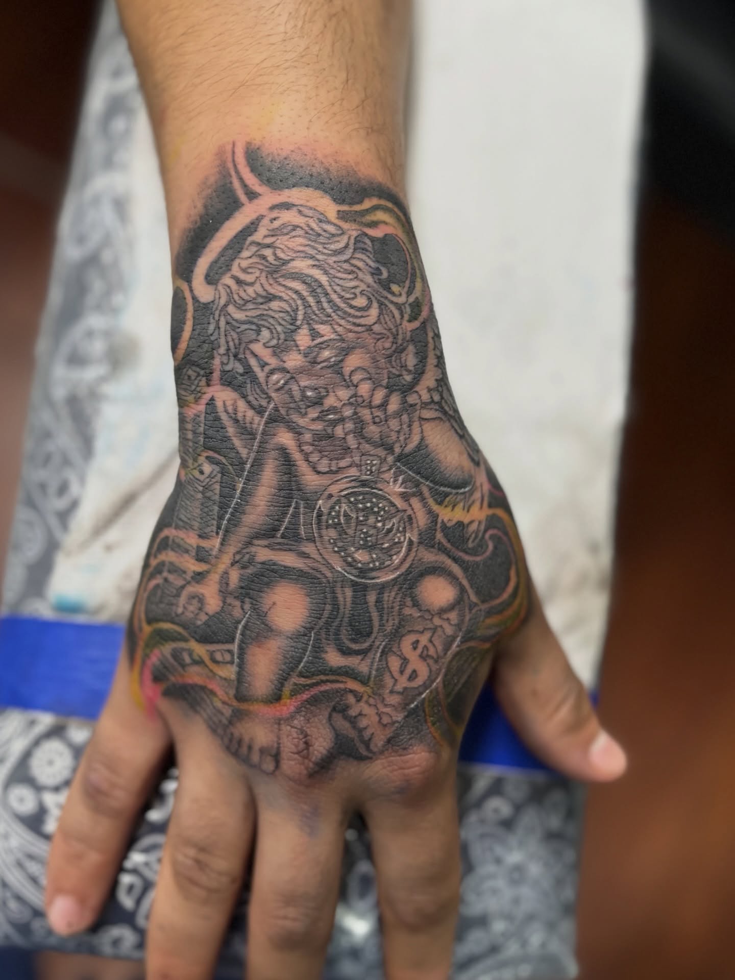 Lion and clock American traditional tattoo on the hand by @tattoosbyadrian