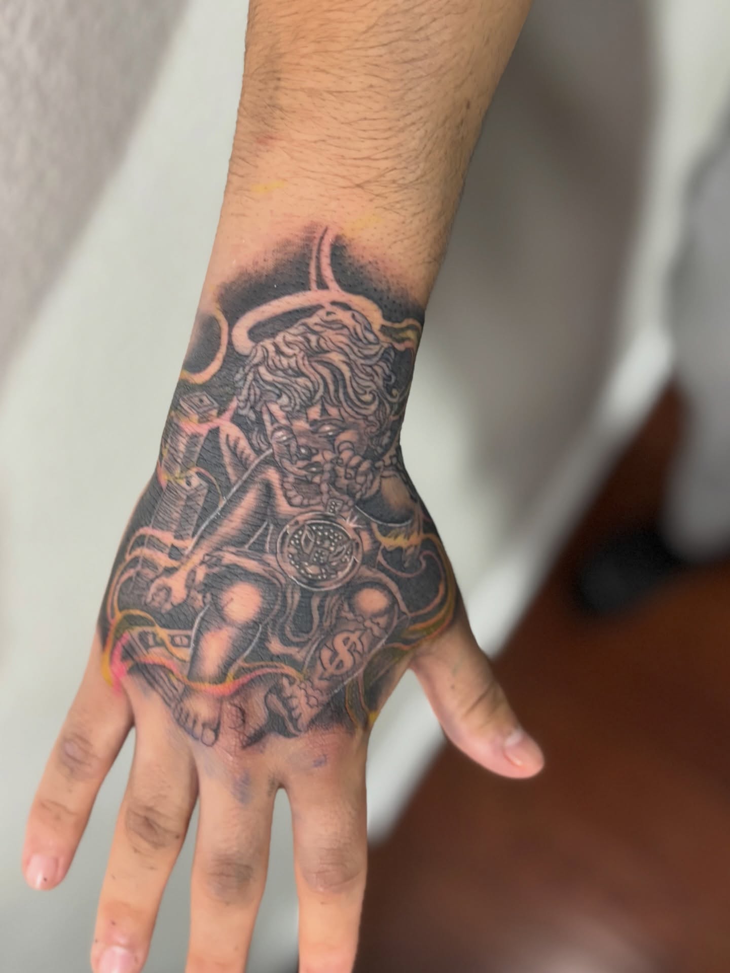 Lion and clock American traditional tattoo on the hand by @tattoosbyadrian