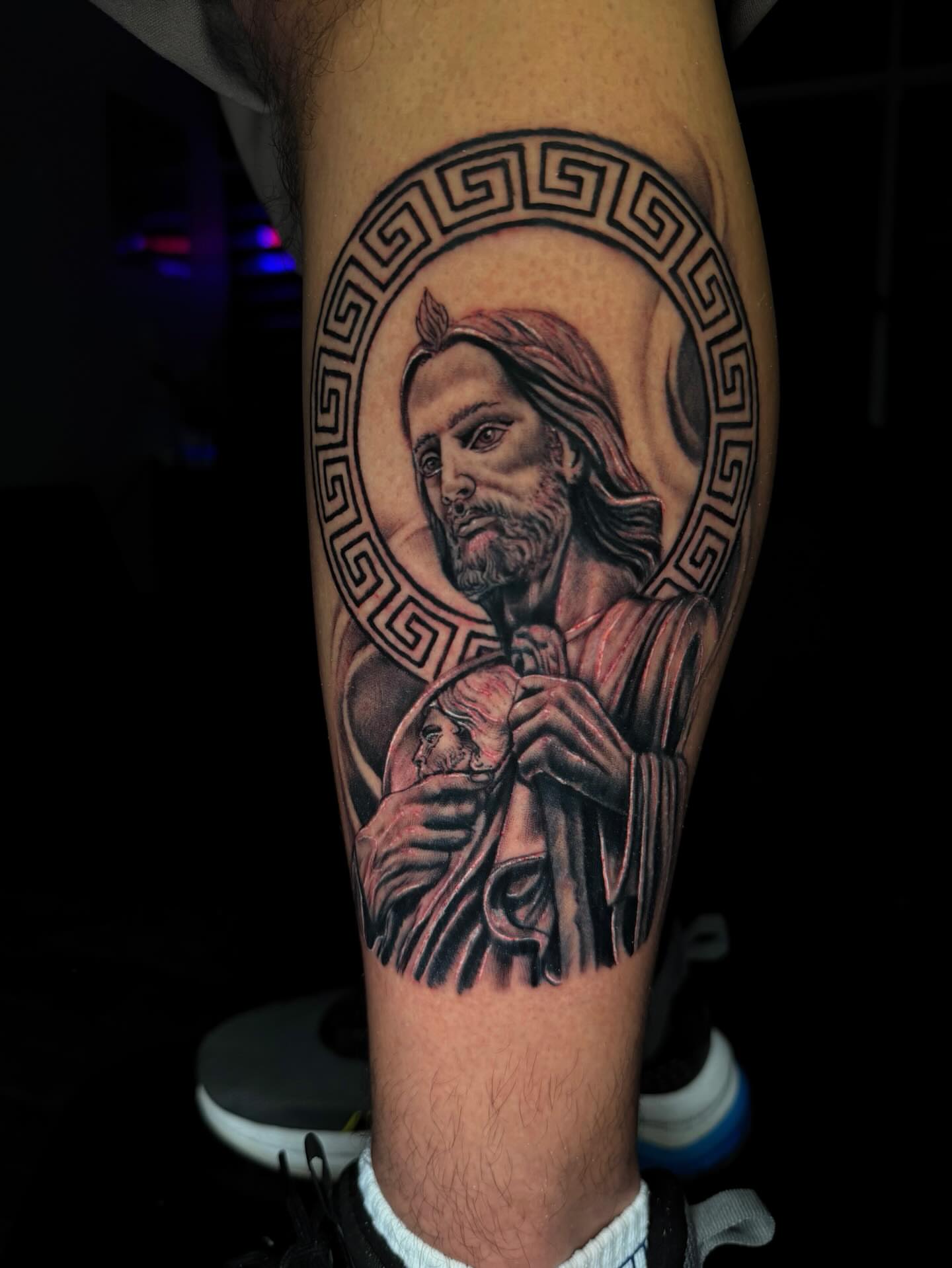 Religious figure holding child realism tattoo on the forearm by Dany