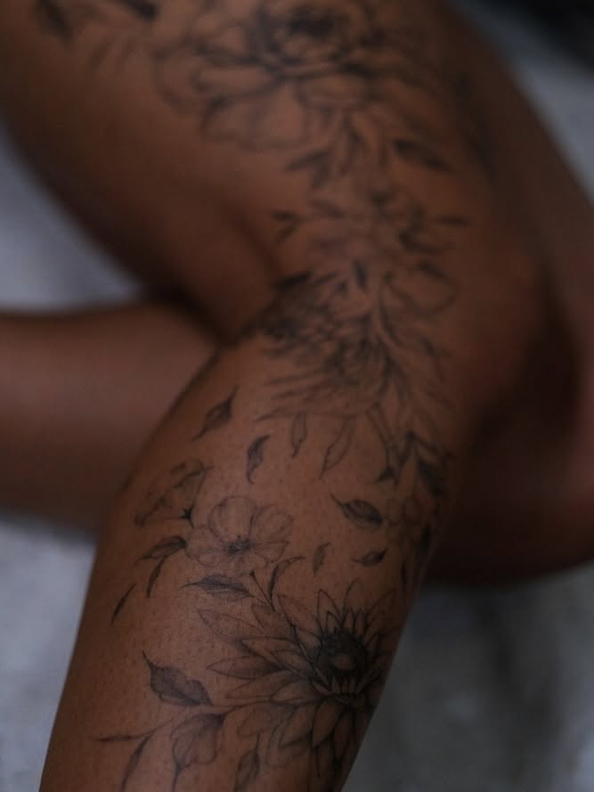 Floral arrangement black and grey tattoo on the upper arm by Temple Adorned Tattoo