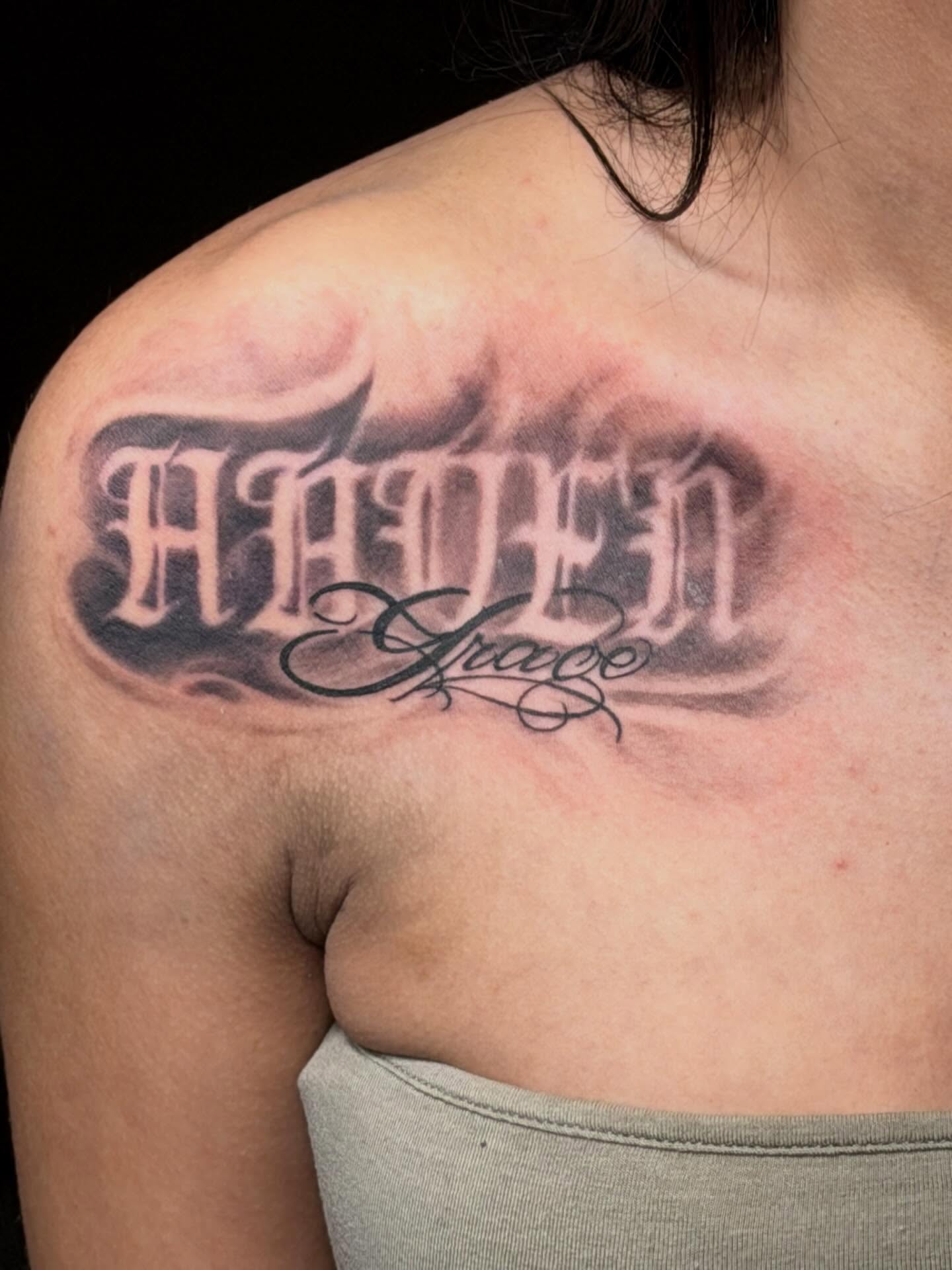Grace lettering script tattoo on the chest by Johnny Scillieri