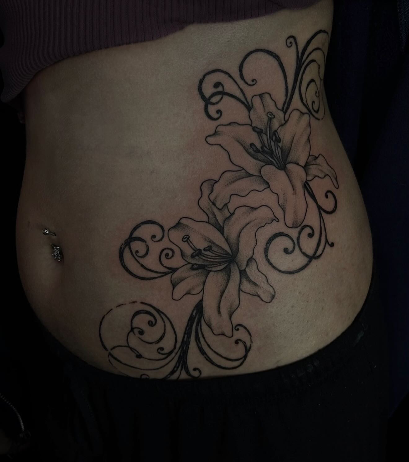 Lily black and grey tattoo on the torso by abby ☽ marie