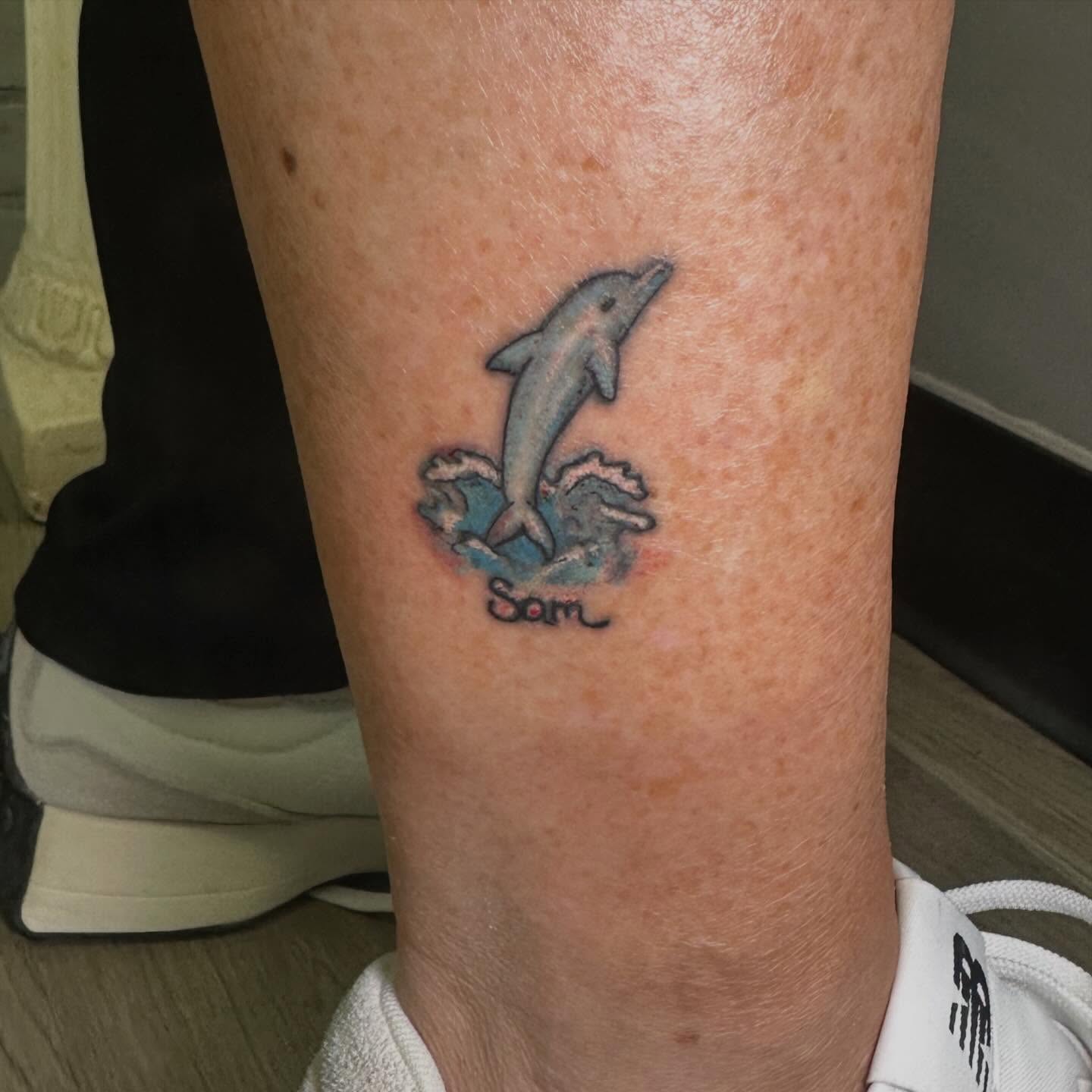 Dolphin new school tattoo on the calf by Sam, Mount Laurel, New Jersey