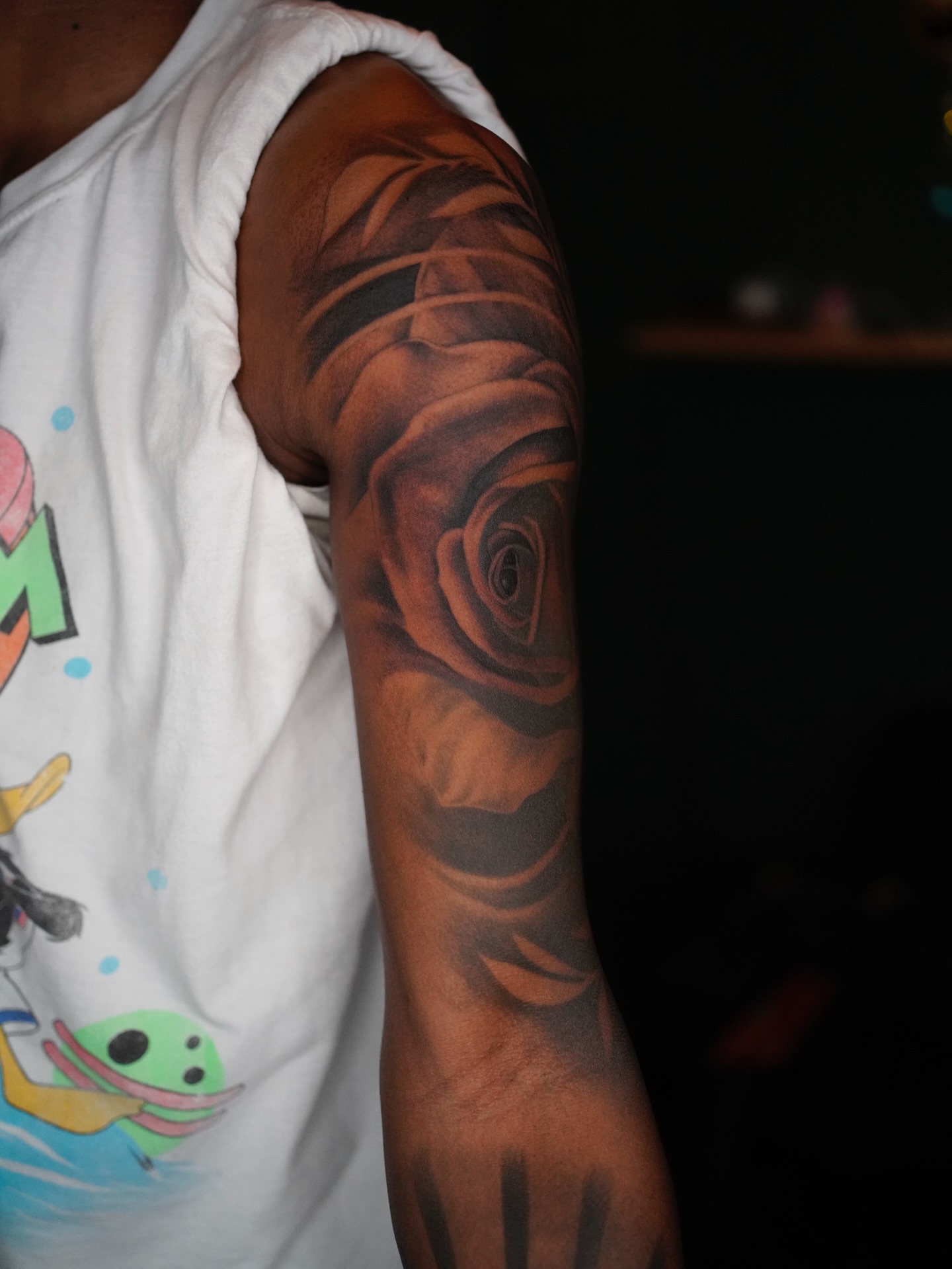 Rose realism tattoo on the upper arm by Jaiden Ducoff