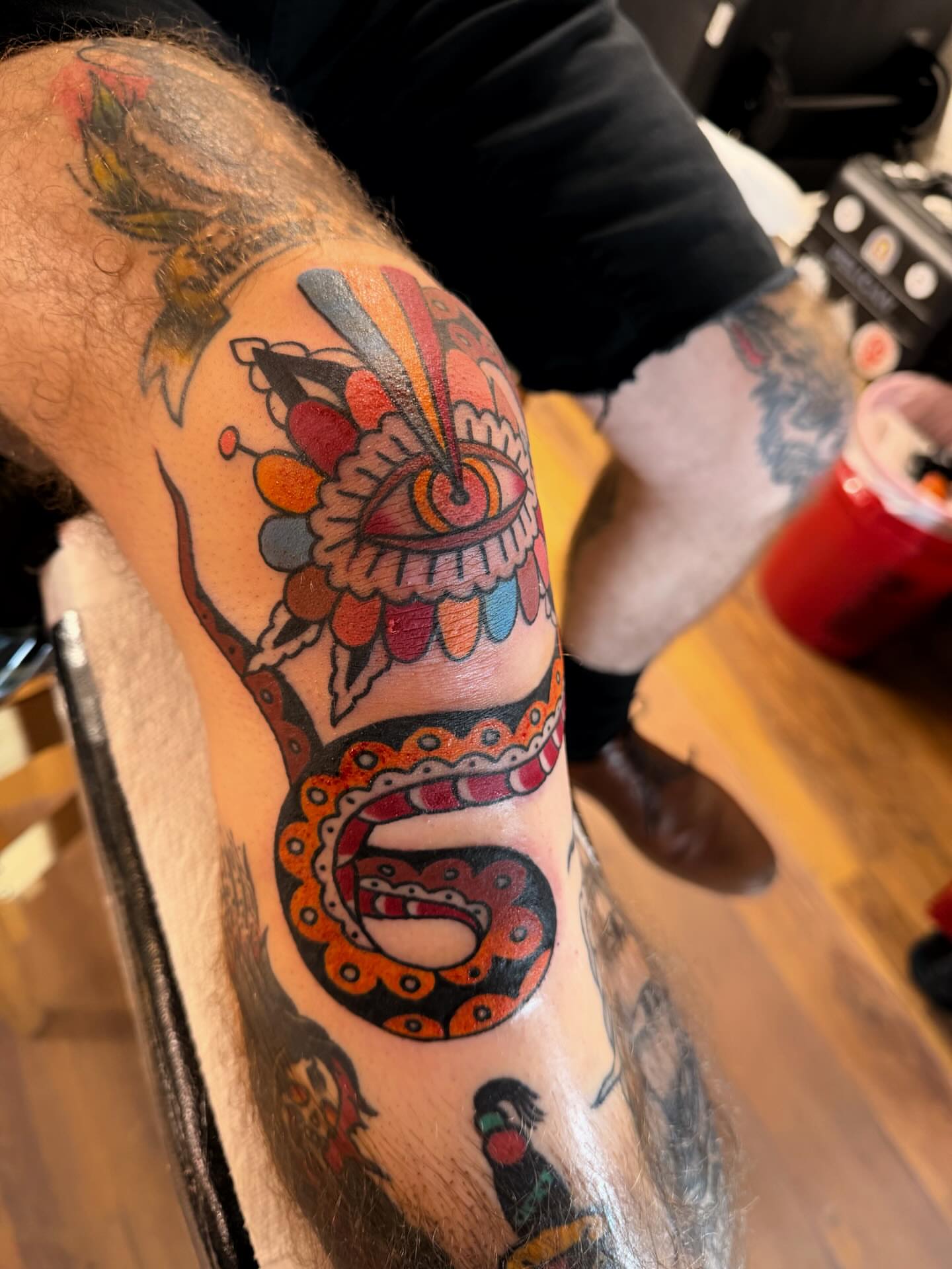 Snake and peony American traditional tattoo on the forearm by Manee Friday