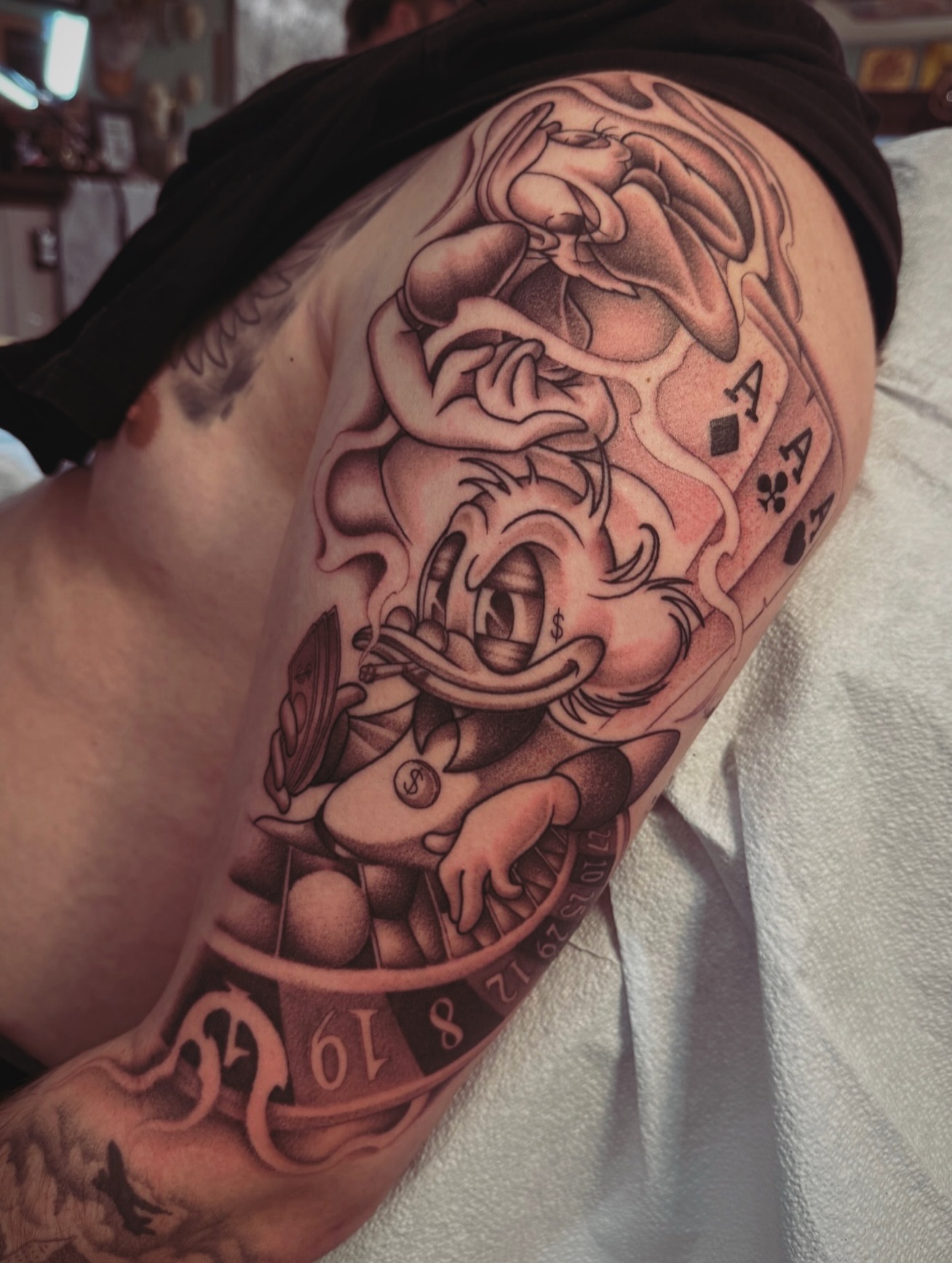 Donald duck American traditional tattoo on the shoulder by Andrew