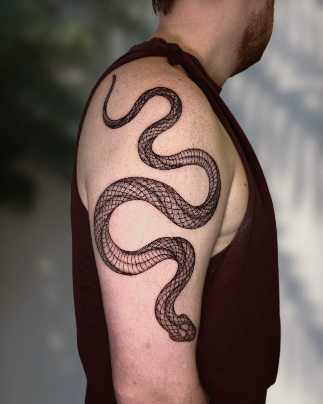 Snake black and grey tattoo on the shoulder by Ingrid Rojas