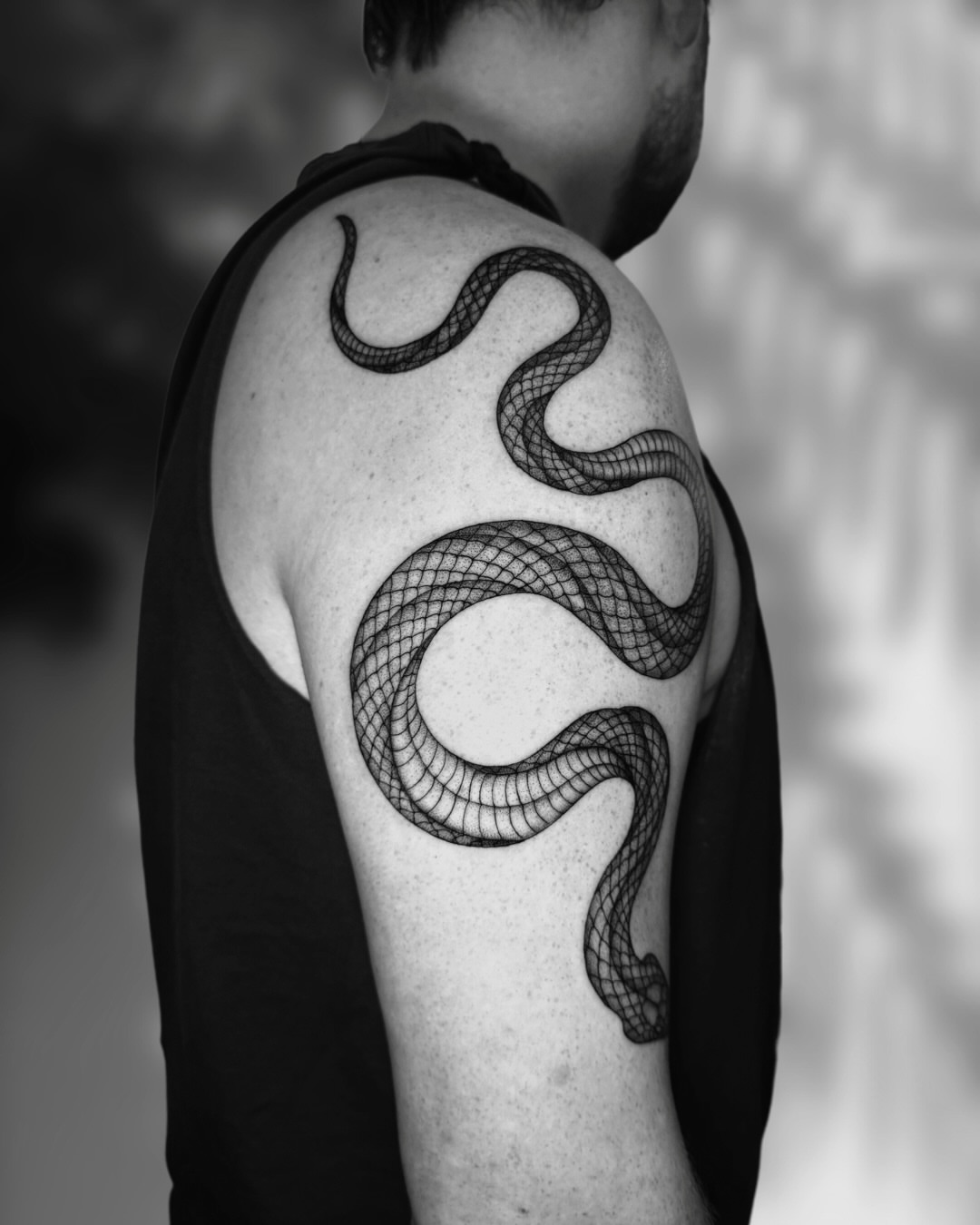 Snake black and grey tattoo on the shoulder by Ingrid Rojas