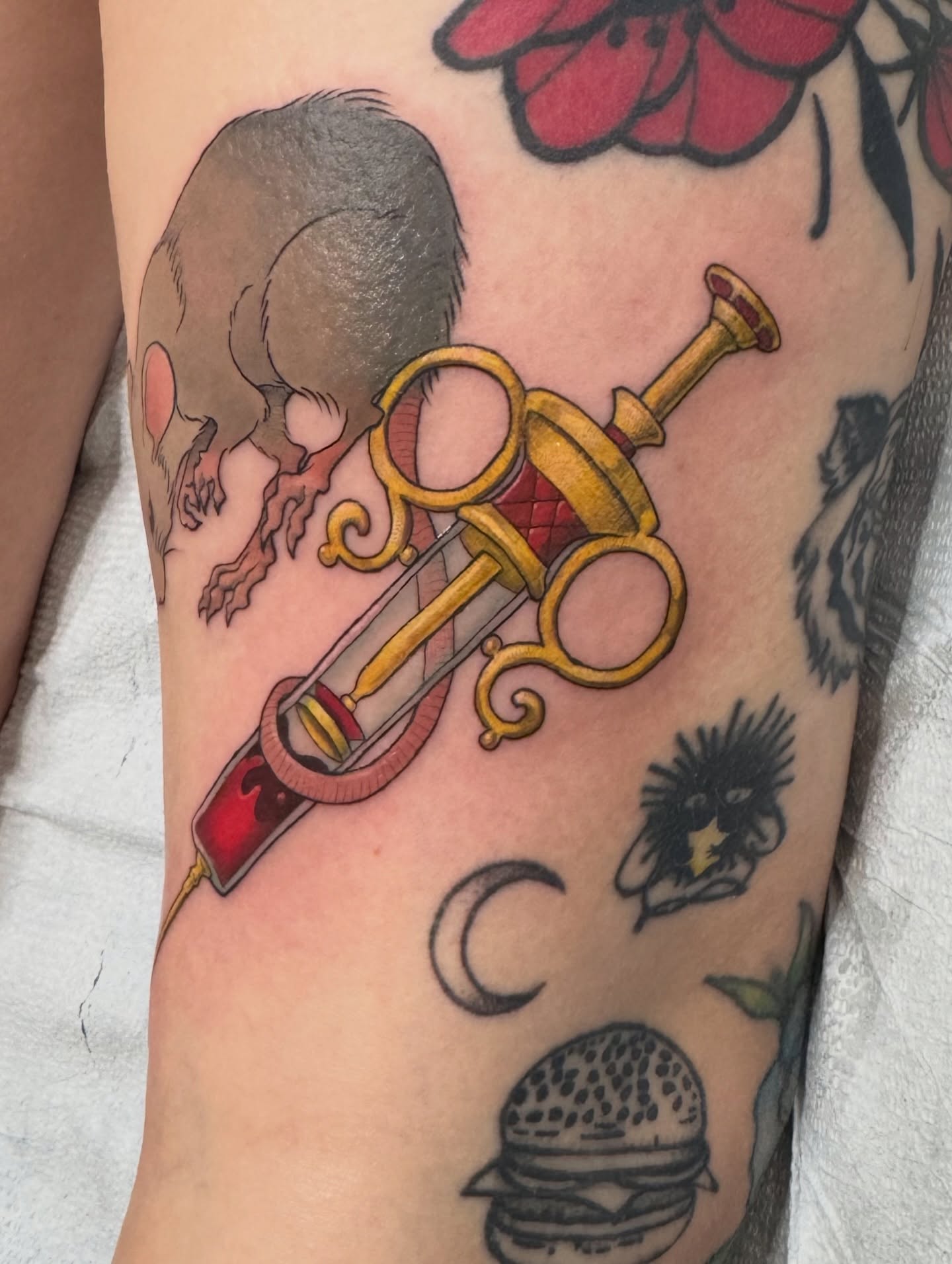 Scissors and syringe American traditional tattoo on the forearm by iz fisch