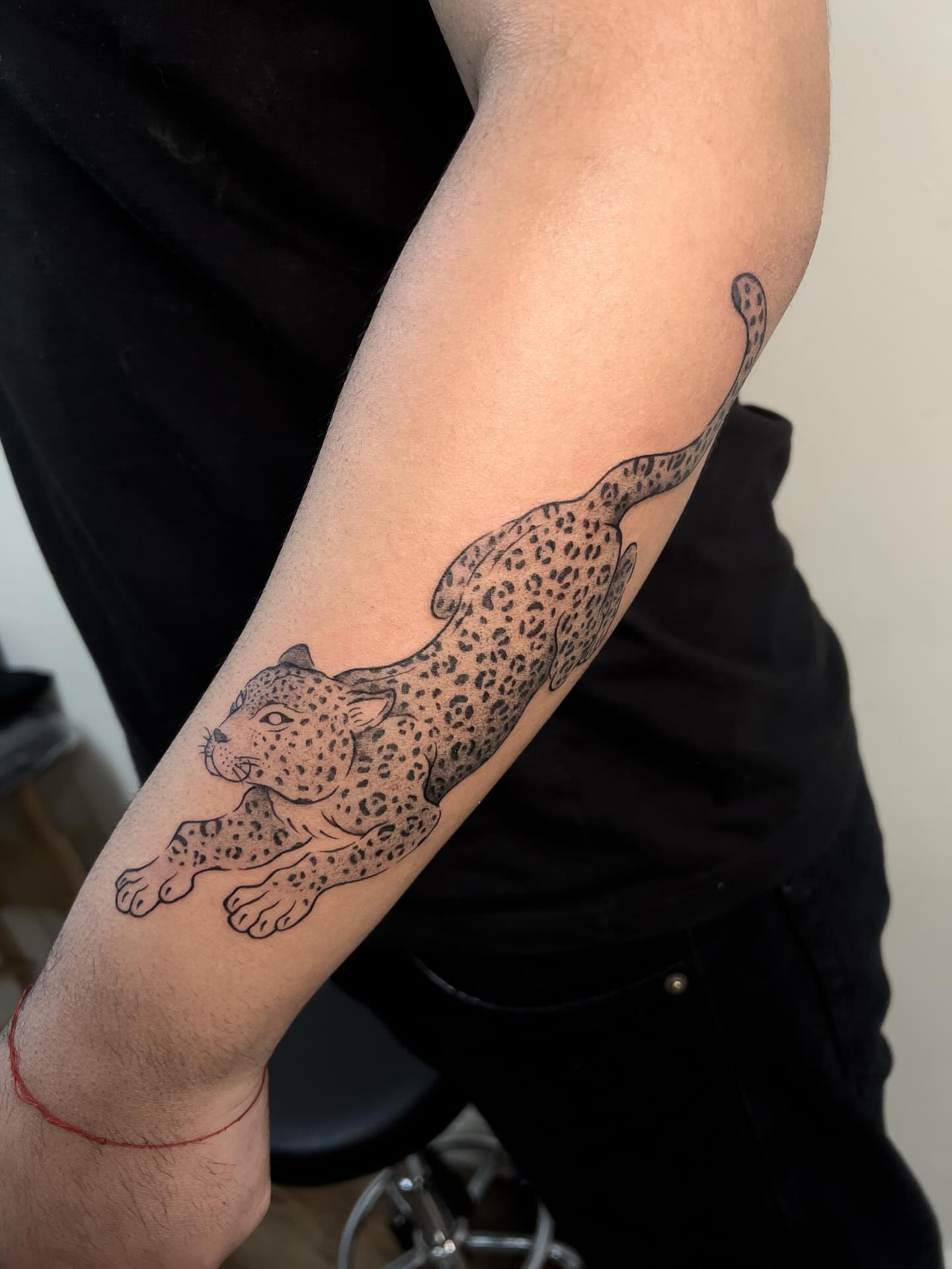 Leopard black and grey tattoo on the forearm by Diana García