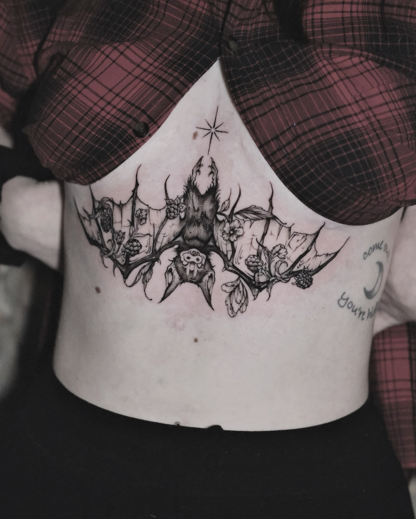 Bat and thorns black and grey tattoo on the ribs by Macayla Myers