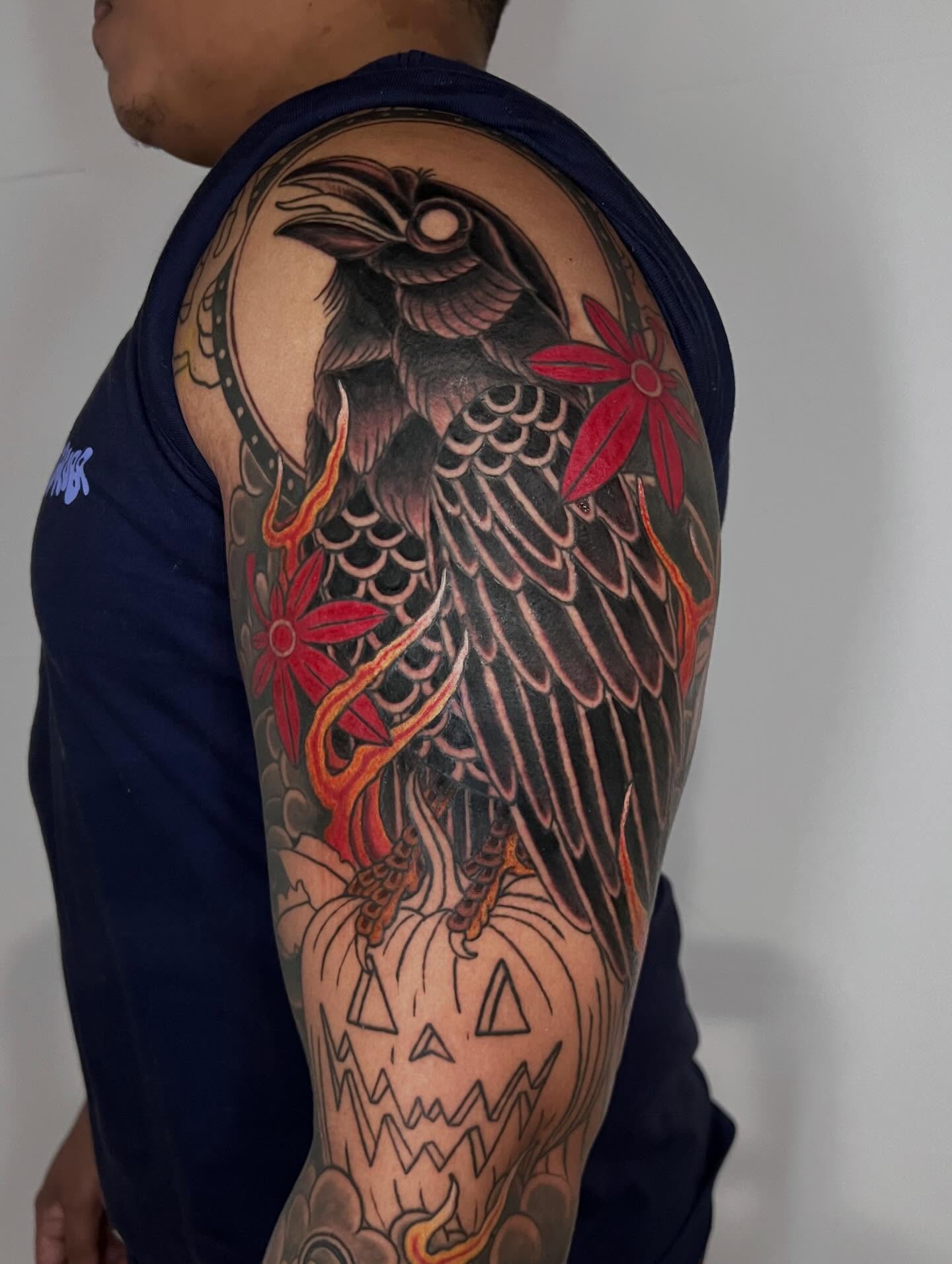 Crow and pumpkin japanese irezumi tattoo on the upper arm by Eoghann McGregor