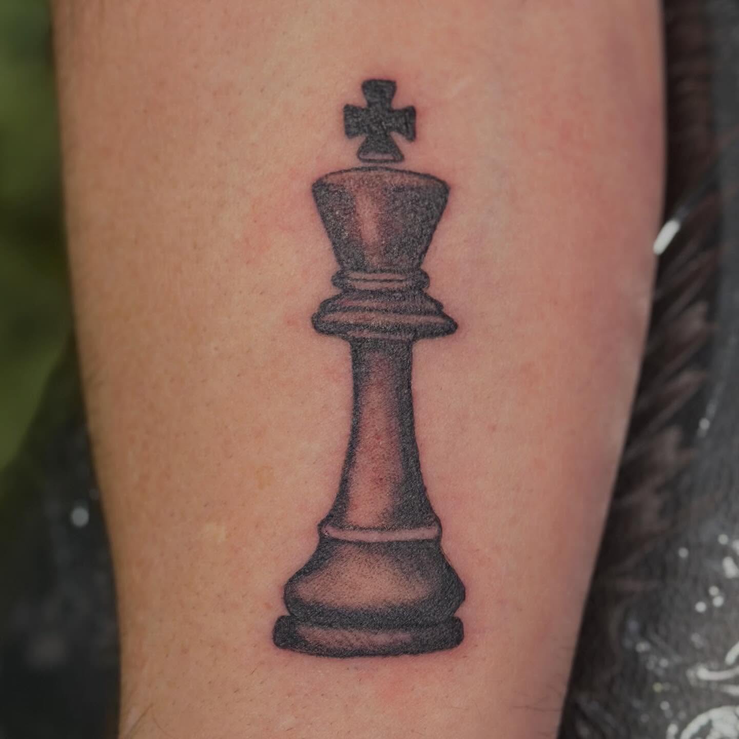 King chess piece black and grey tattoo on the forearm by Zen Forbes