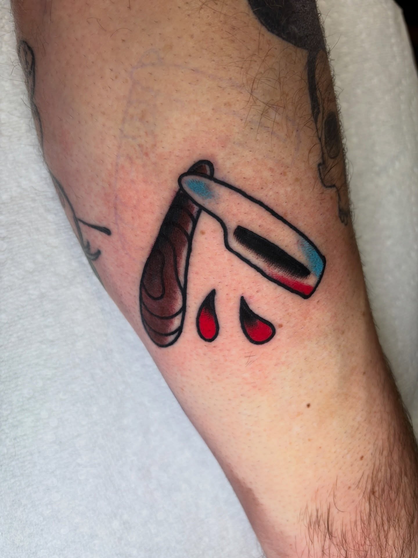 Knife and blood American traditional tattoo on the forearm by AARON MASTERS - Tattoo Artist