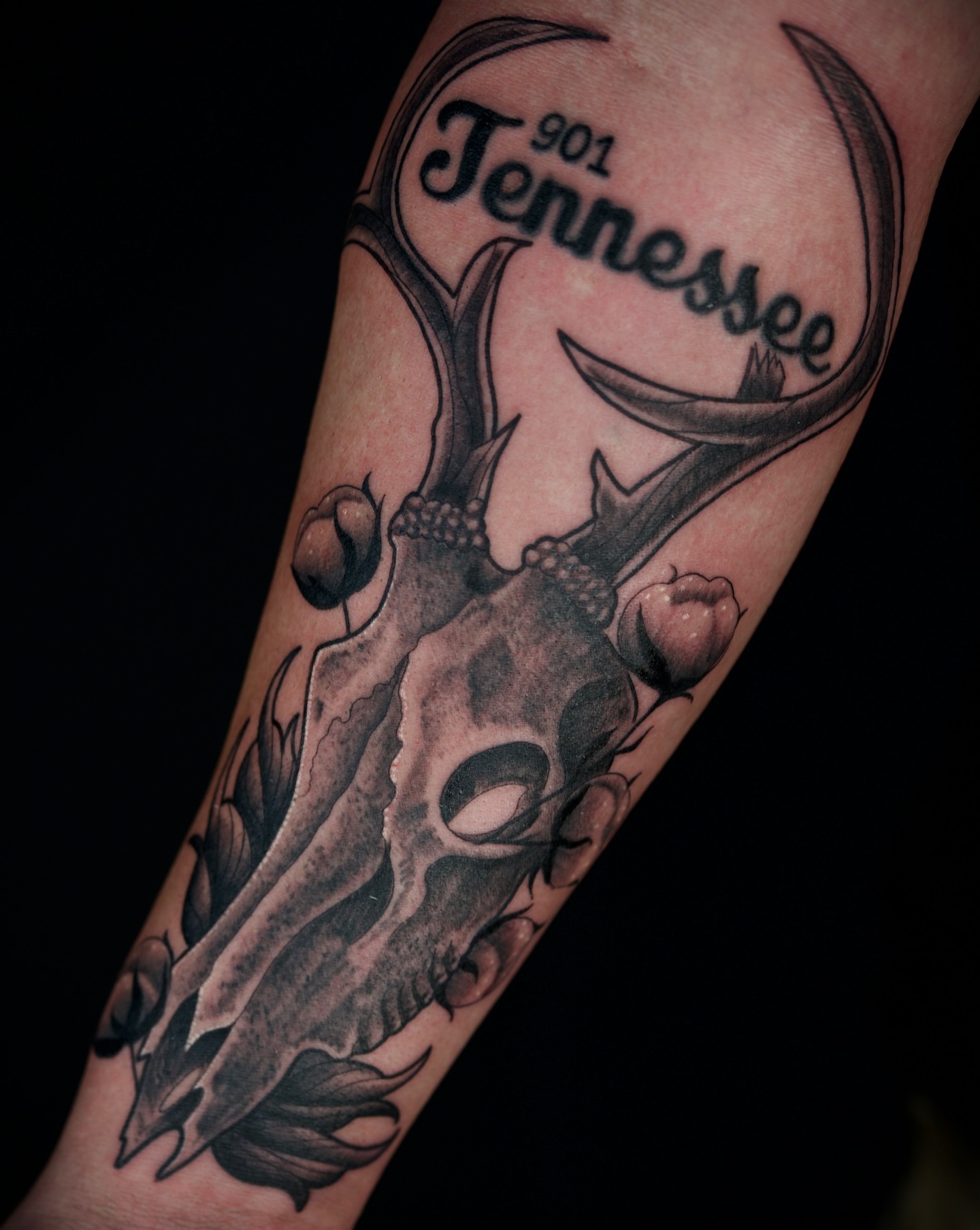 Deer skull black and grey tattoo on the forearm by Chris Lochbihler