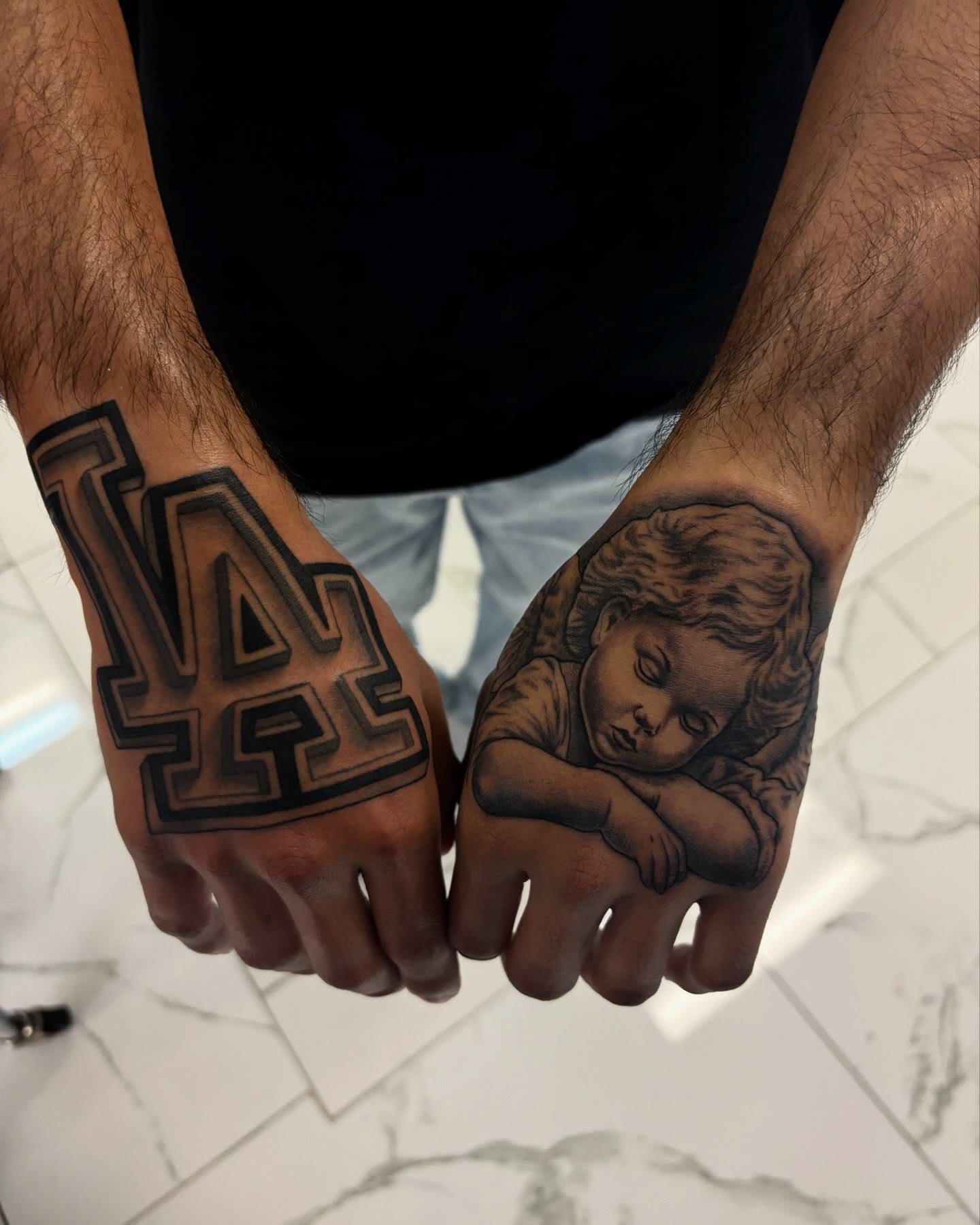 LA logo black and grey tattoo on the hand by Cristiano Ochoa, Elk Grove, California