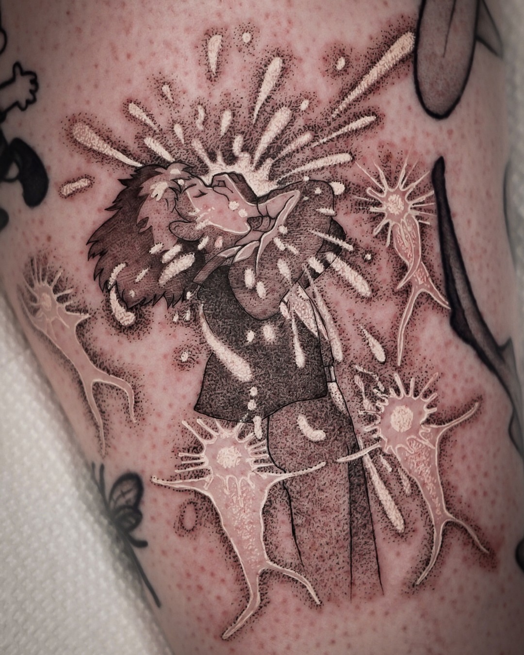 Exploding character dotwork tattoo on the upper arm by Chris Jang