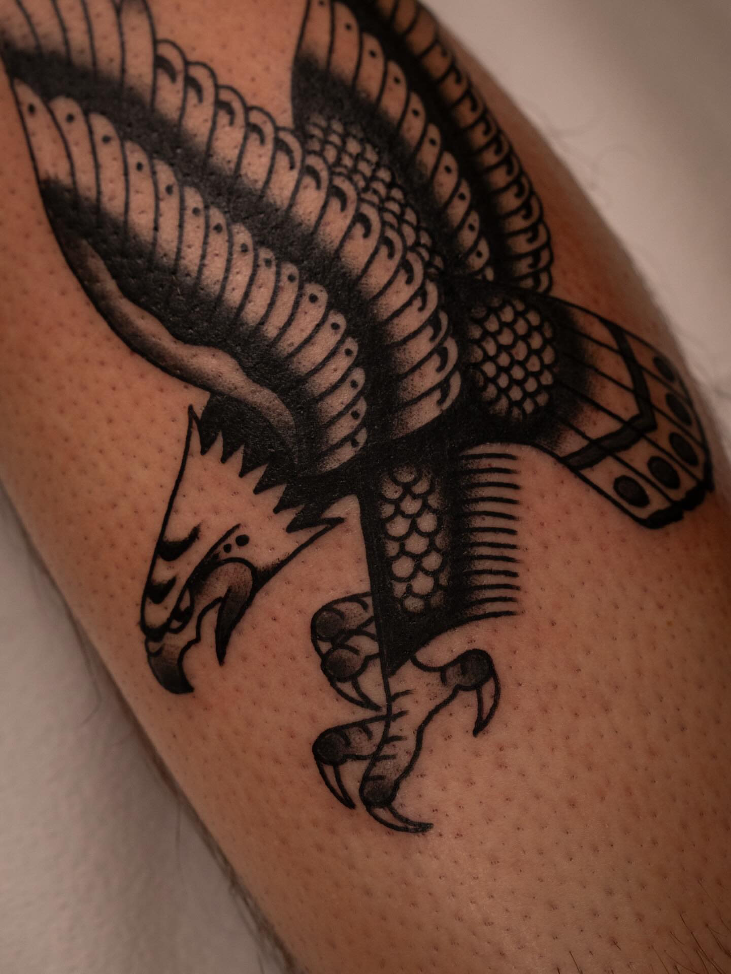 Eagle black and grey tattoo on the forearm by Justin Rakowski