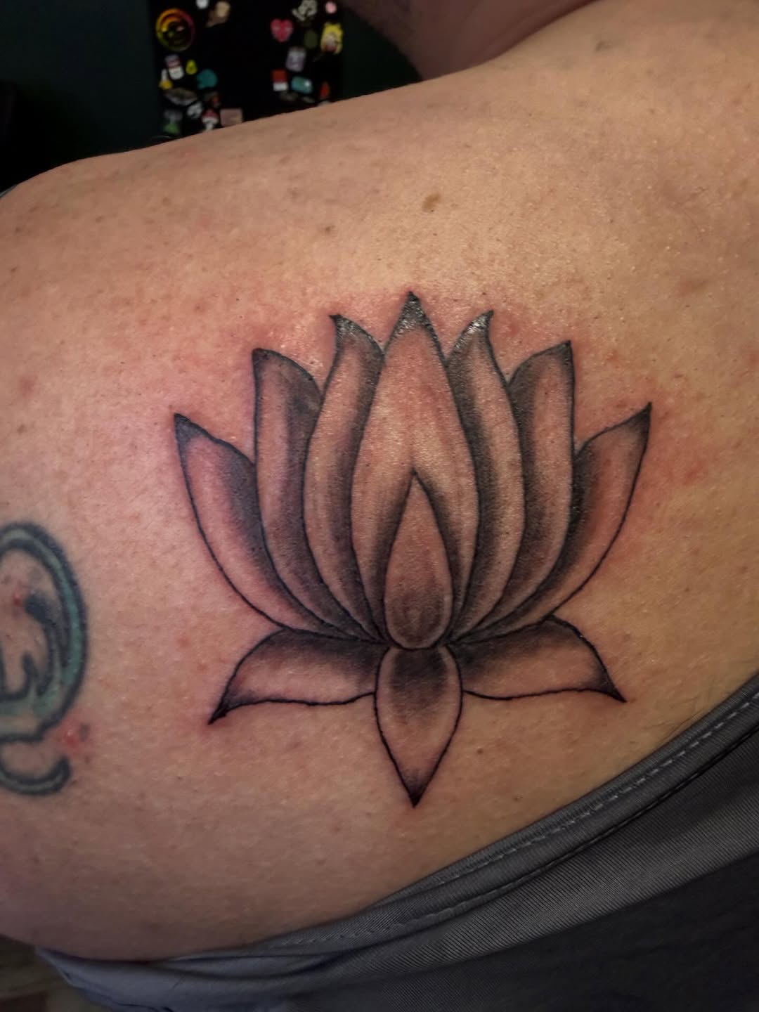 Lotus flower dotwork tattoo on the shoulder by K. Bel Art