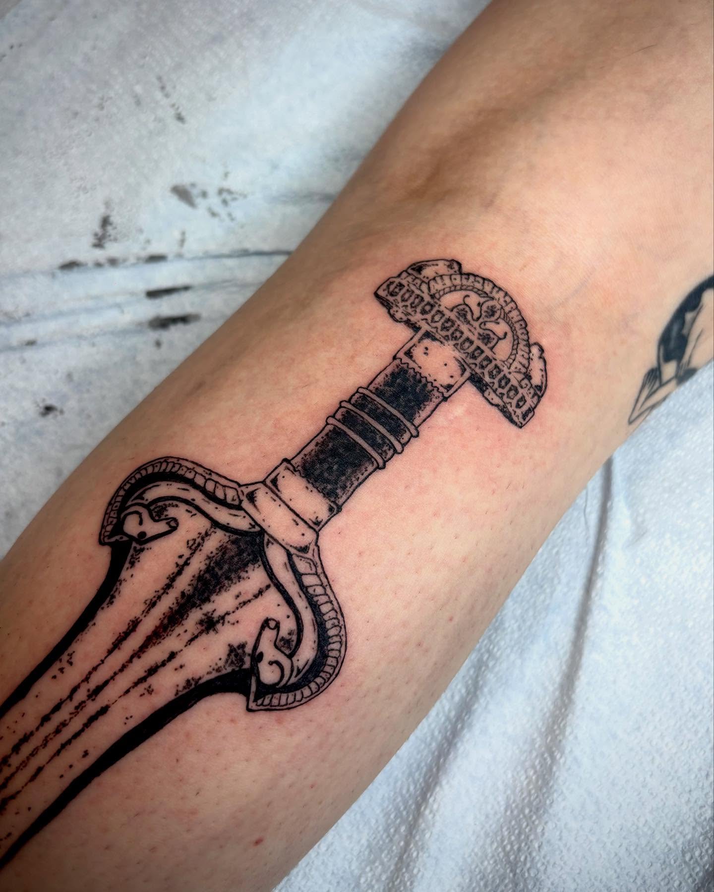 Sword black and grey tattoo on the forearm by kendle