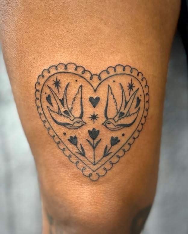 Swallows and heart American traditional tattoo on the thigh by David