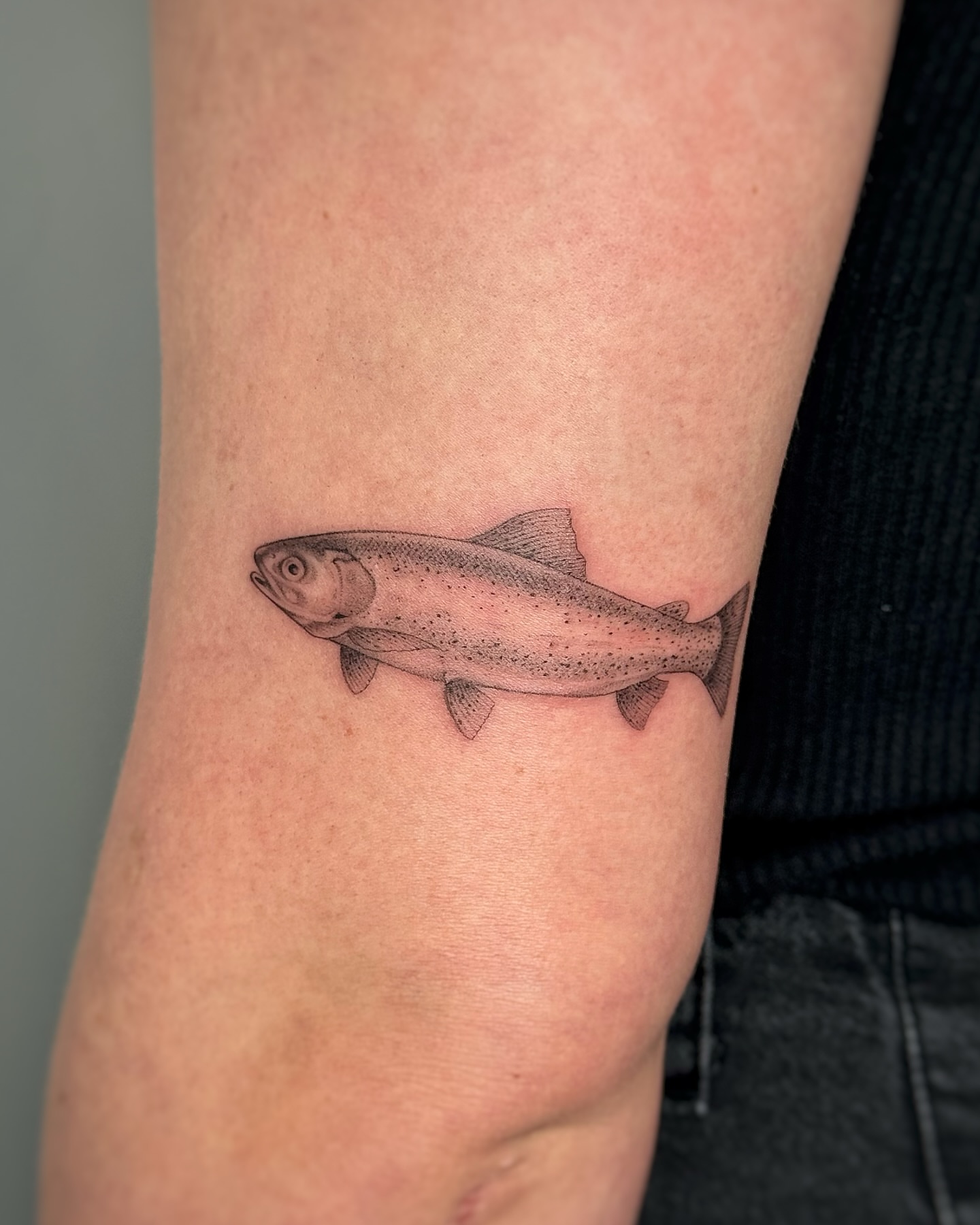 Rainbow trout realism tattoo on the forearm by Lea Burkard, Berkeley, California