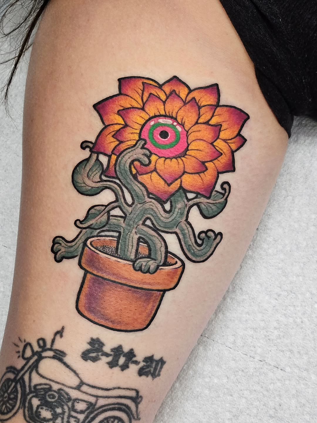 Flower with tentacles American traditional tattoo on the thigh by Bellz Rehder