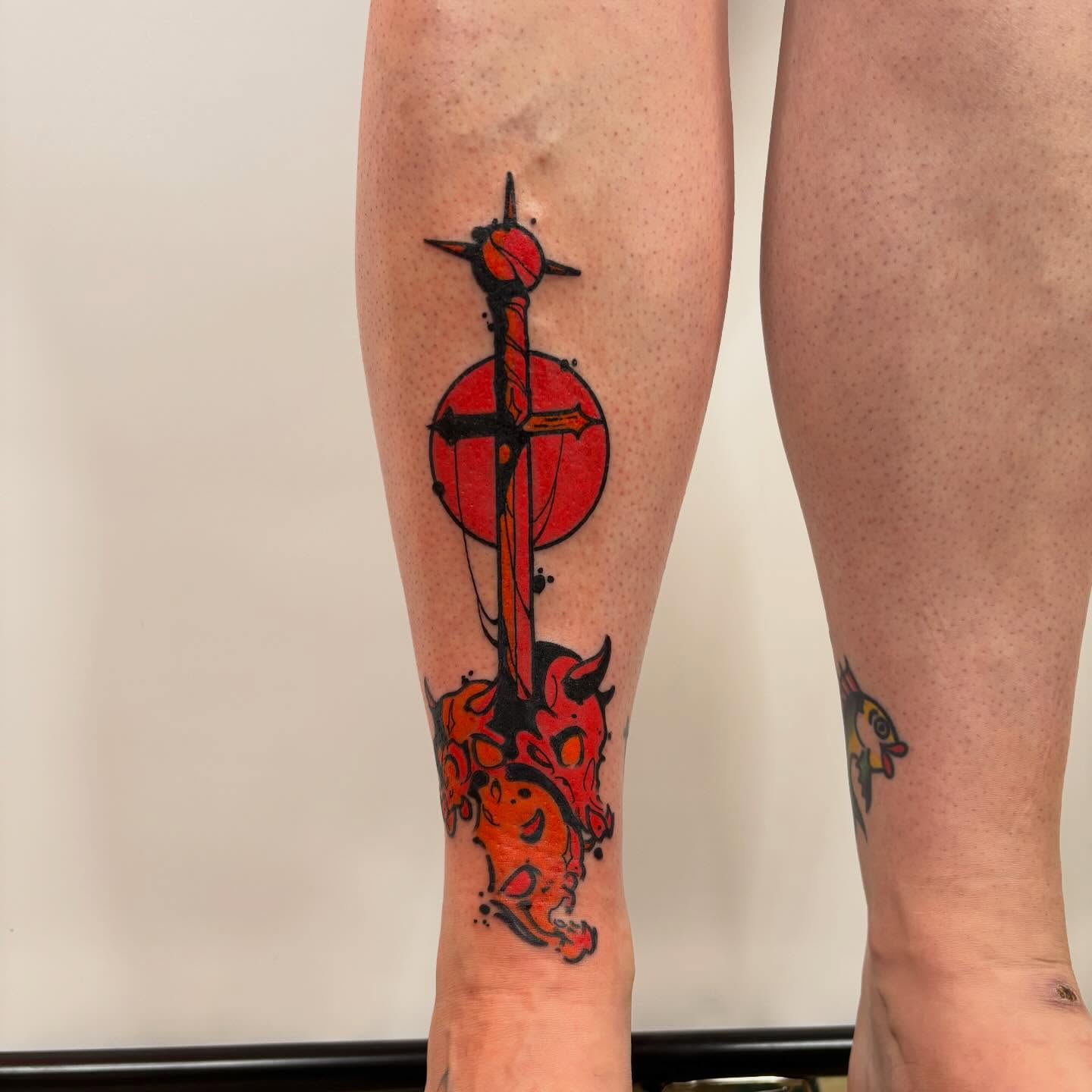 Sword and sun American traditional tattoo on the calf by Ghost Ham Tattoos