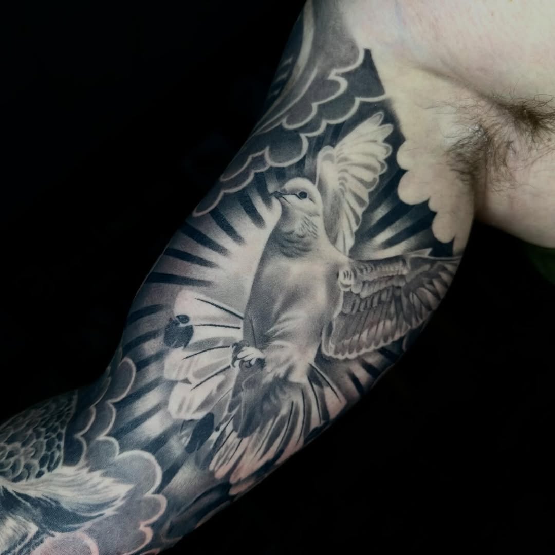 Dove with rays of light realism tattoo on the forearm by DH Tattooing
