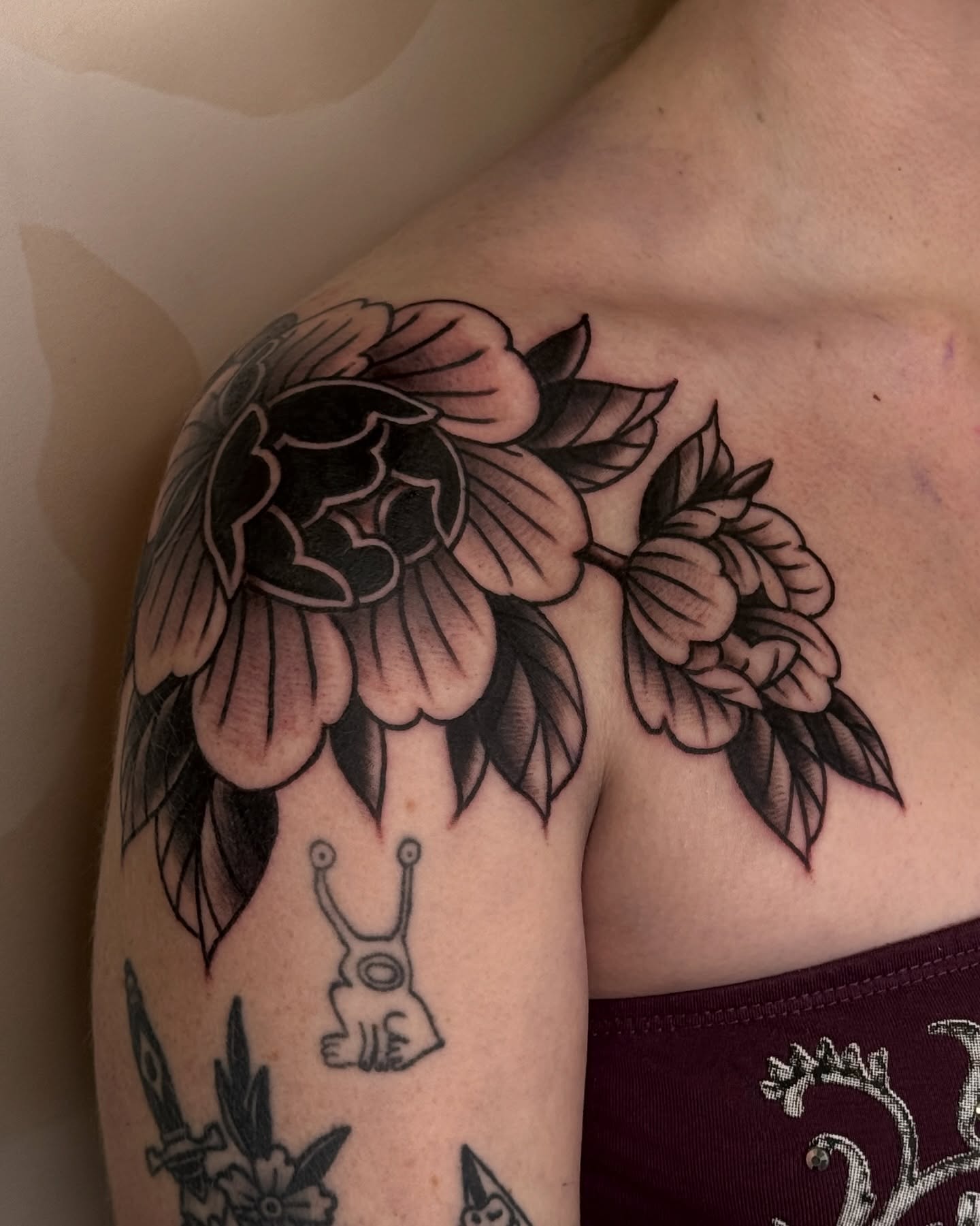 Floral arrangement black and grey tattoo on the shoulder by Bre Grover, Vancouver, British Columbia