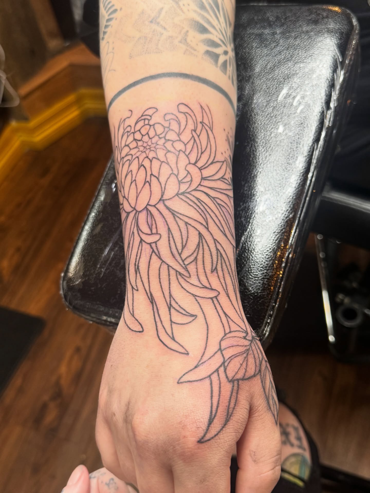 Chrysanthemum black and grey tattoo on the forearm by Teagan Rachel, Millcreek, Utah