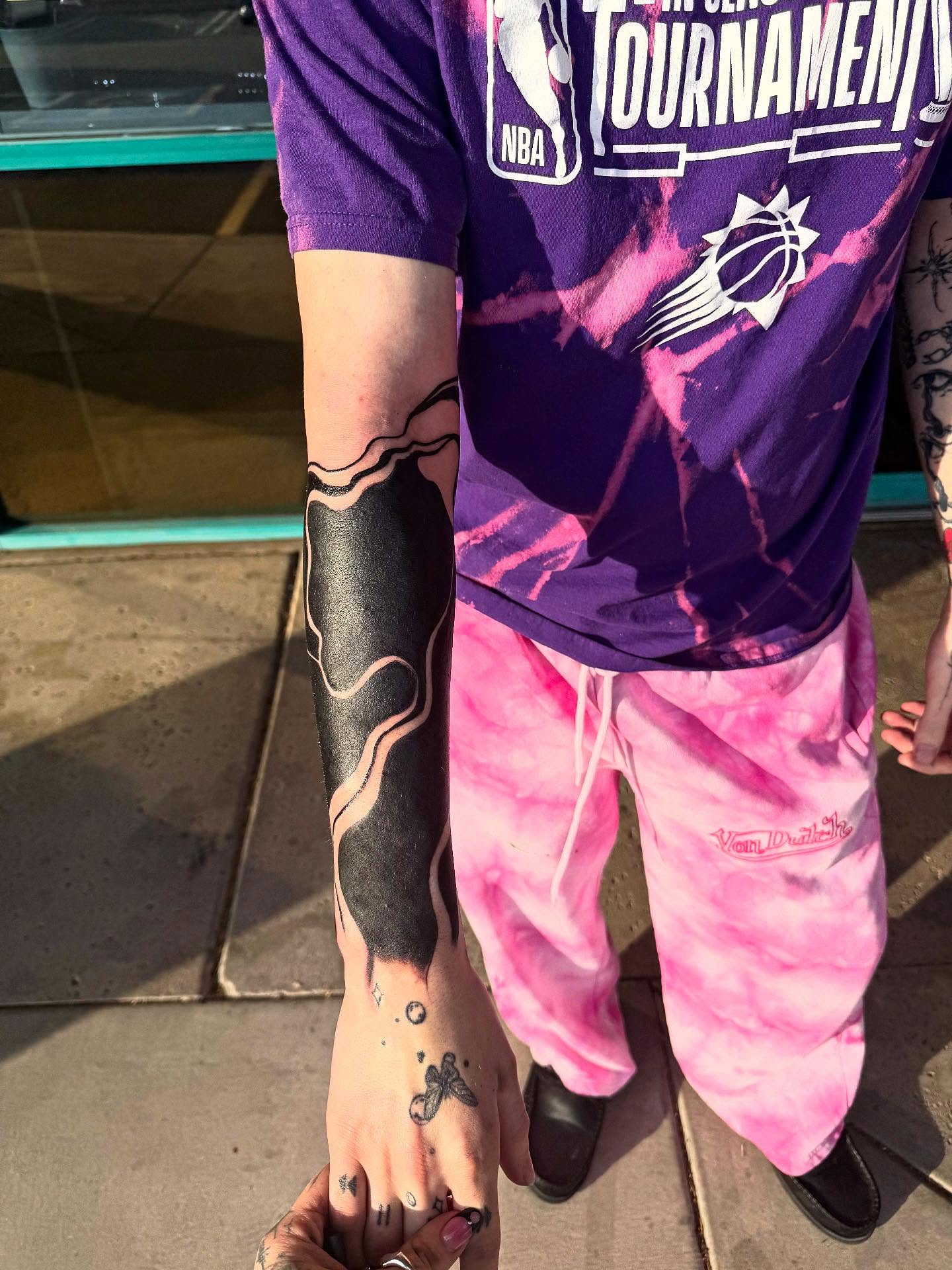 Abstract wave black and grey tattoo on the forearm by McKenna Hughes