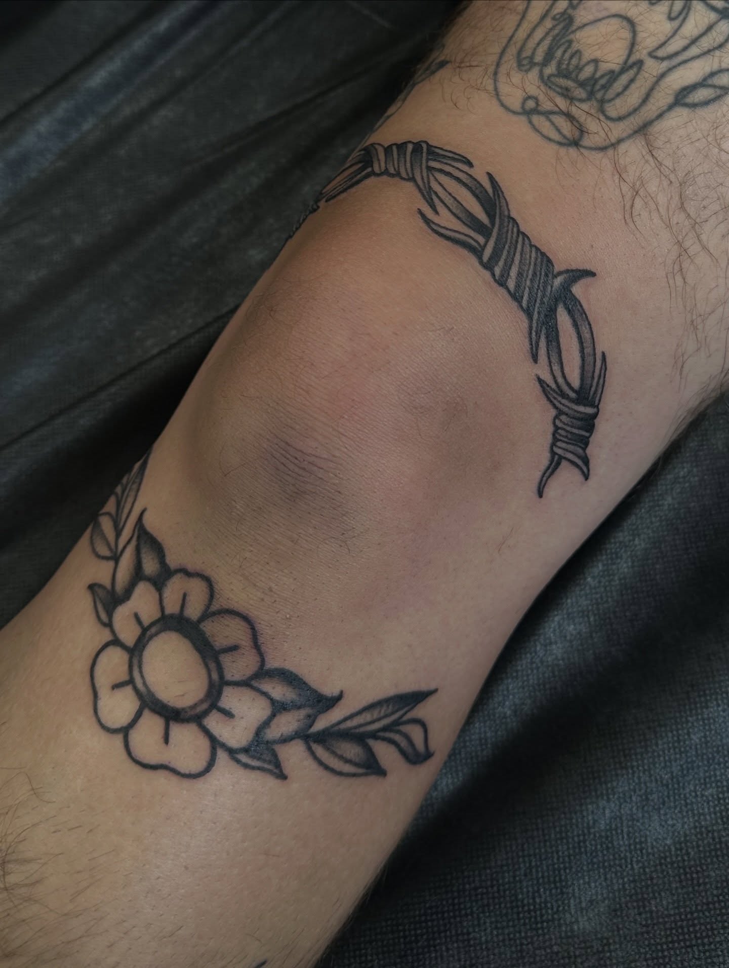 Barbed wire and flower black and grey tattoo on the forearm by Ciera Farni, Murray, Utah